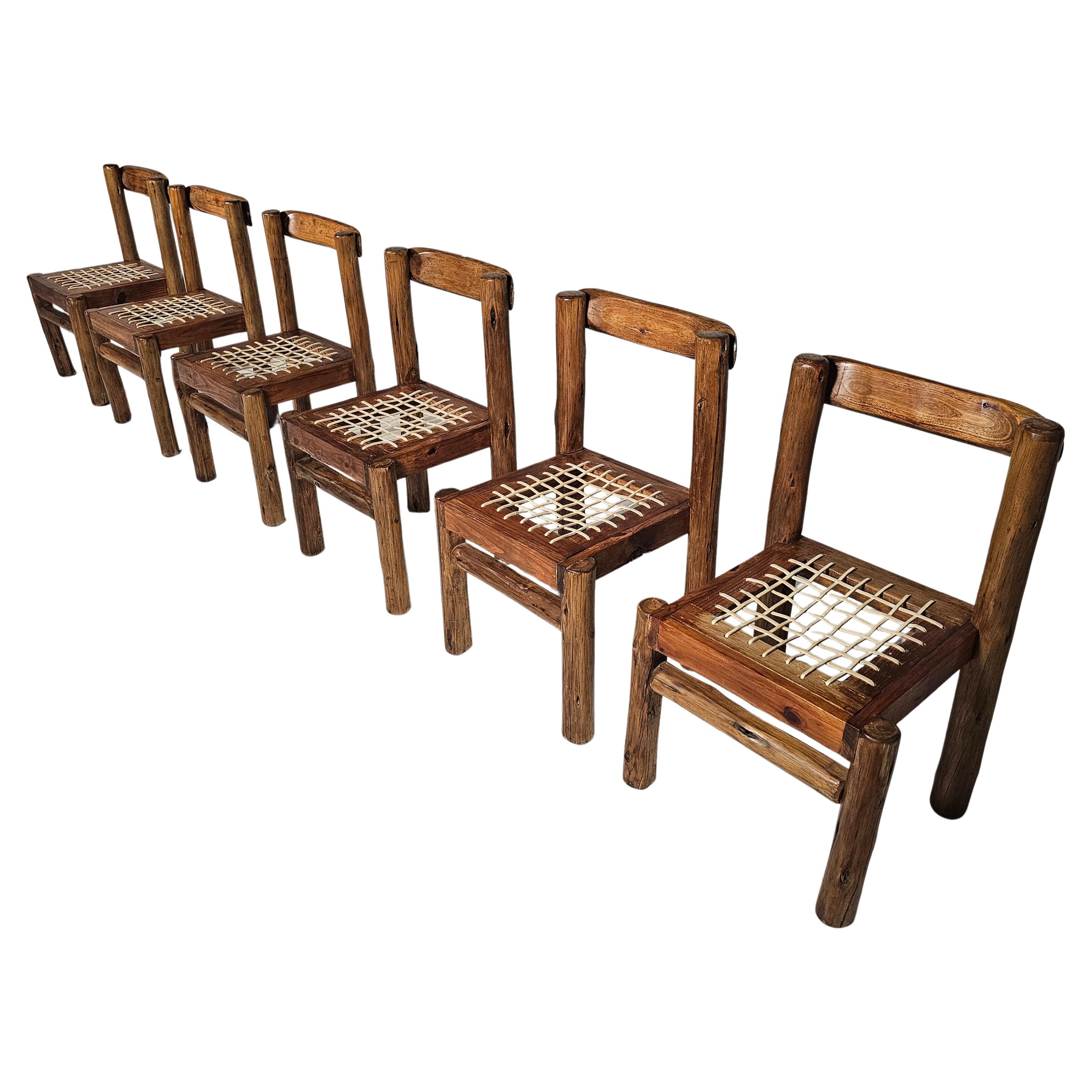 Set of 6 brutalist solid pinewood dining chairs from the 1970s. Bulky chairs with amazing seating comfort because of the slightly curved top of the backrest. Cream leather strap seats.

Defined by clean, smooth lines, and excellent joinery, each of