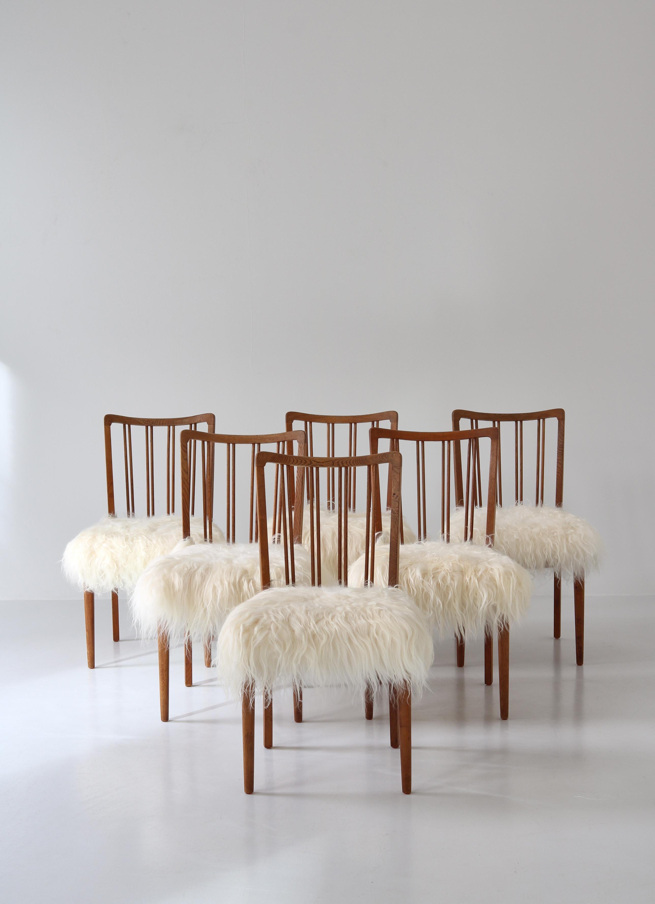 Scandinave moderne Ensemble de 6 chaises à dossier fuseau « Modèle 101 » en peau de mouton et chêne, Danemark, années 1950 en vente