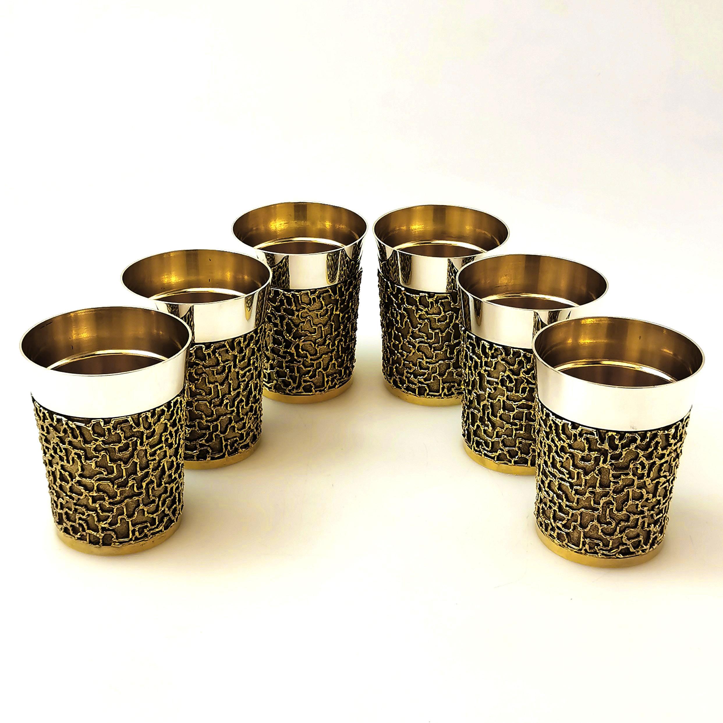 A magnificent Set of 6 solid Silver Beakers with a parcel-gilt finish made by the renowned silversmith Stuart Devlin. The exterior of the Cups has a plain solid silver band around the top and the rest of the body has a textured gilt base with a