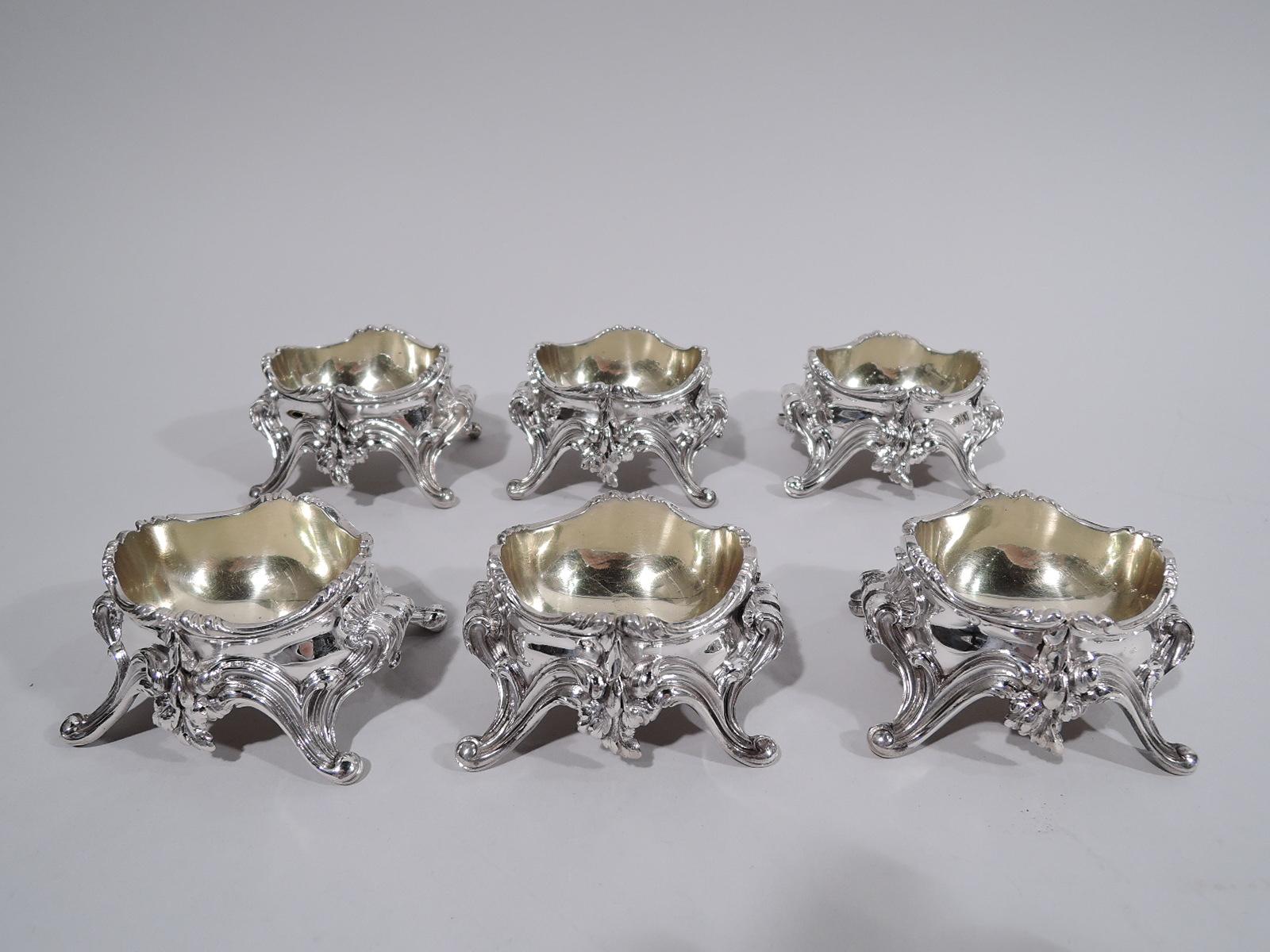 Set of 6 Rococo 950 silver open salts. Made by Boin-Taburet in Paris, ca 1890. Each: Oval gilt-washed bowl on 4 splayed volute-scroll supports. Ends also volute-scrolled with scallop shell mounts. Sides have foliate aprons. Sumptuous and sculptural