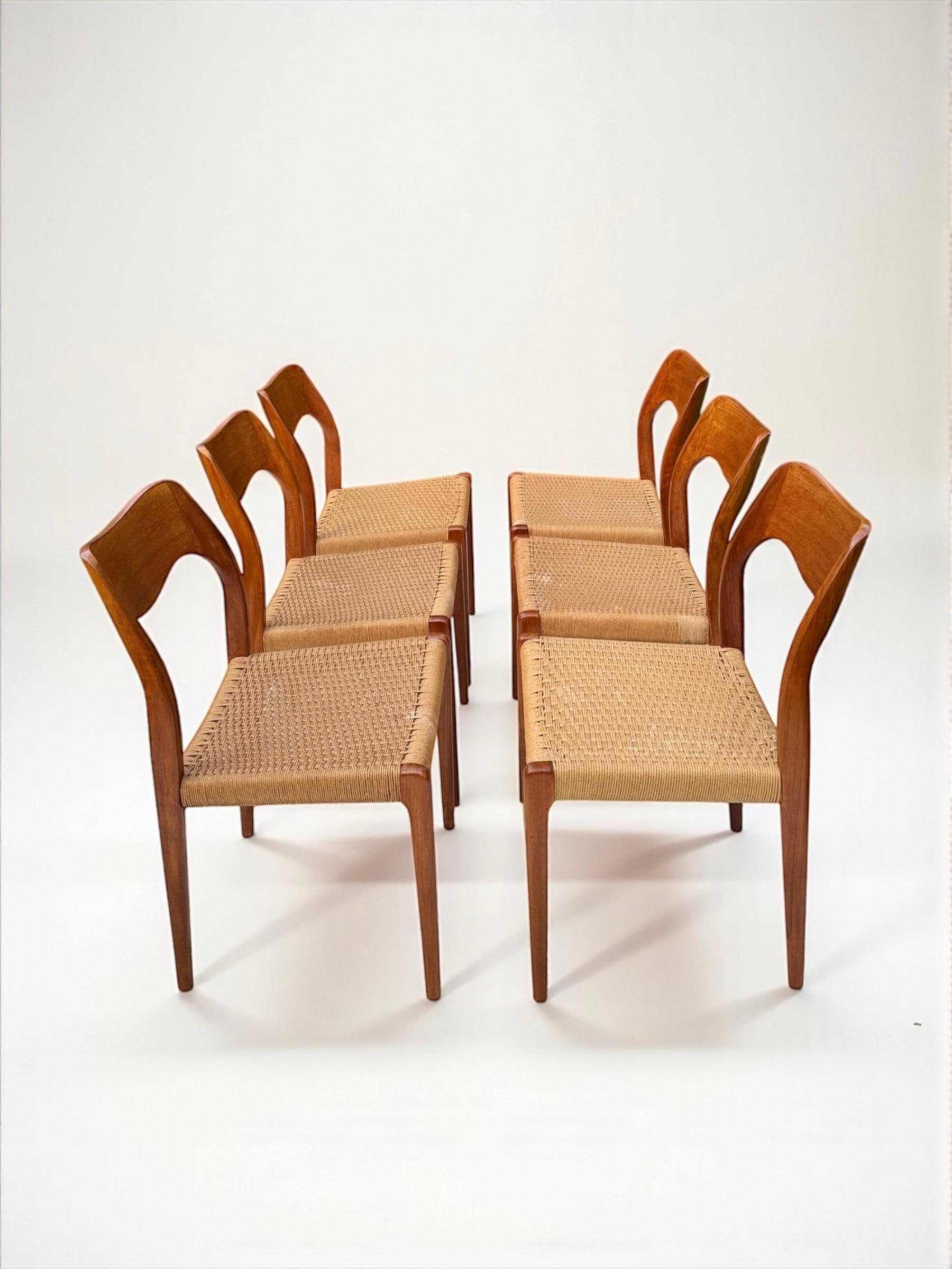 This set of four dining room chairs, model 71, designed by Niels Otto Møller in the 1960s, is an excellent example of Danish mid-century modern design. The chairs combine the natural beauty of teak wood with paper wicker, creating an elegant and