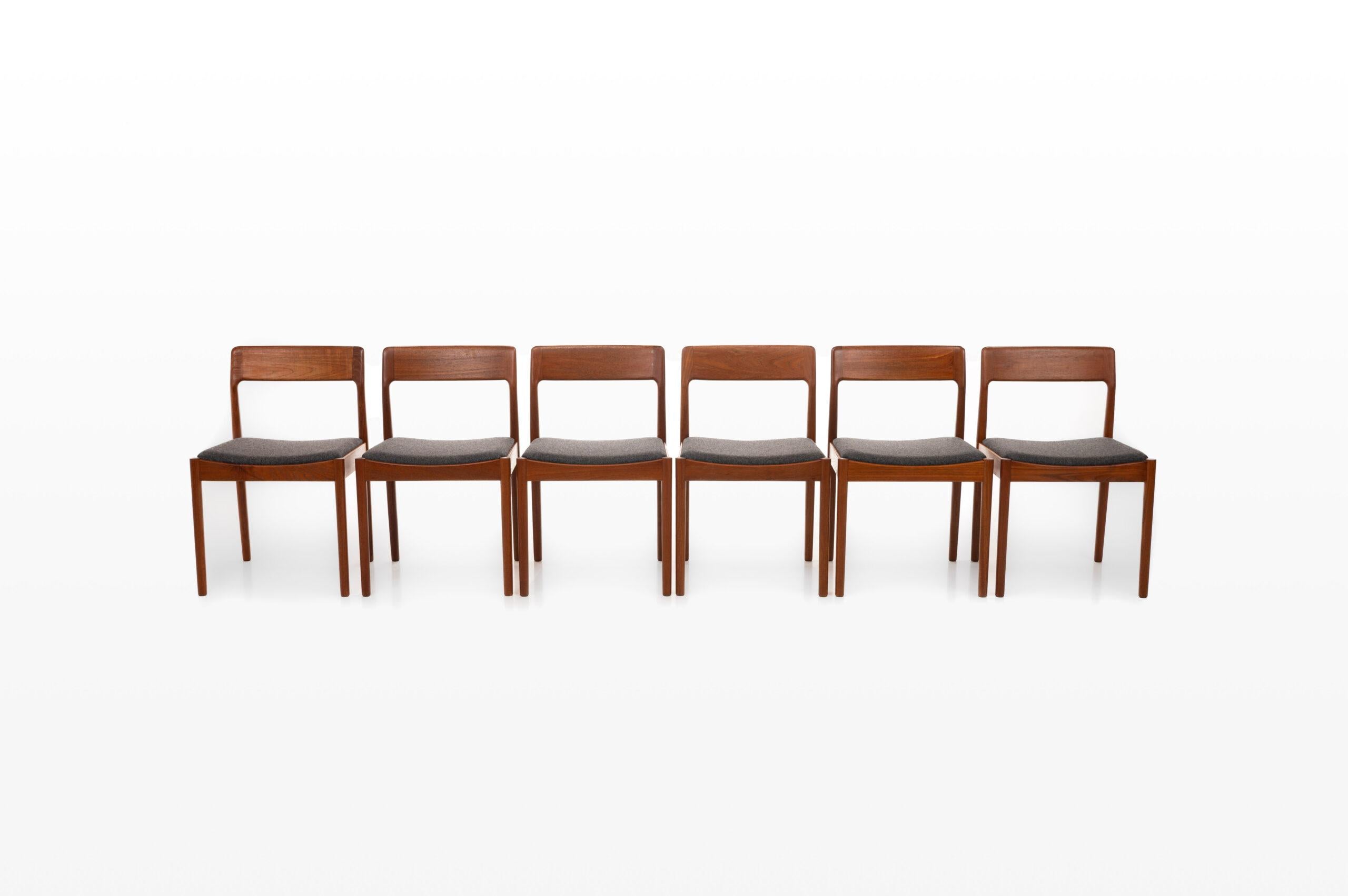 Set of six teak dining chairs designed by Johannes Norgaard for Norgaard Mobelfabrik. Beautifully designed teak frame and reupholstered with a dark gray upholstery.
 