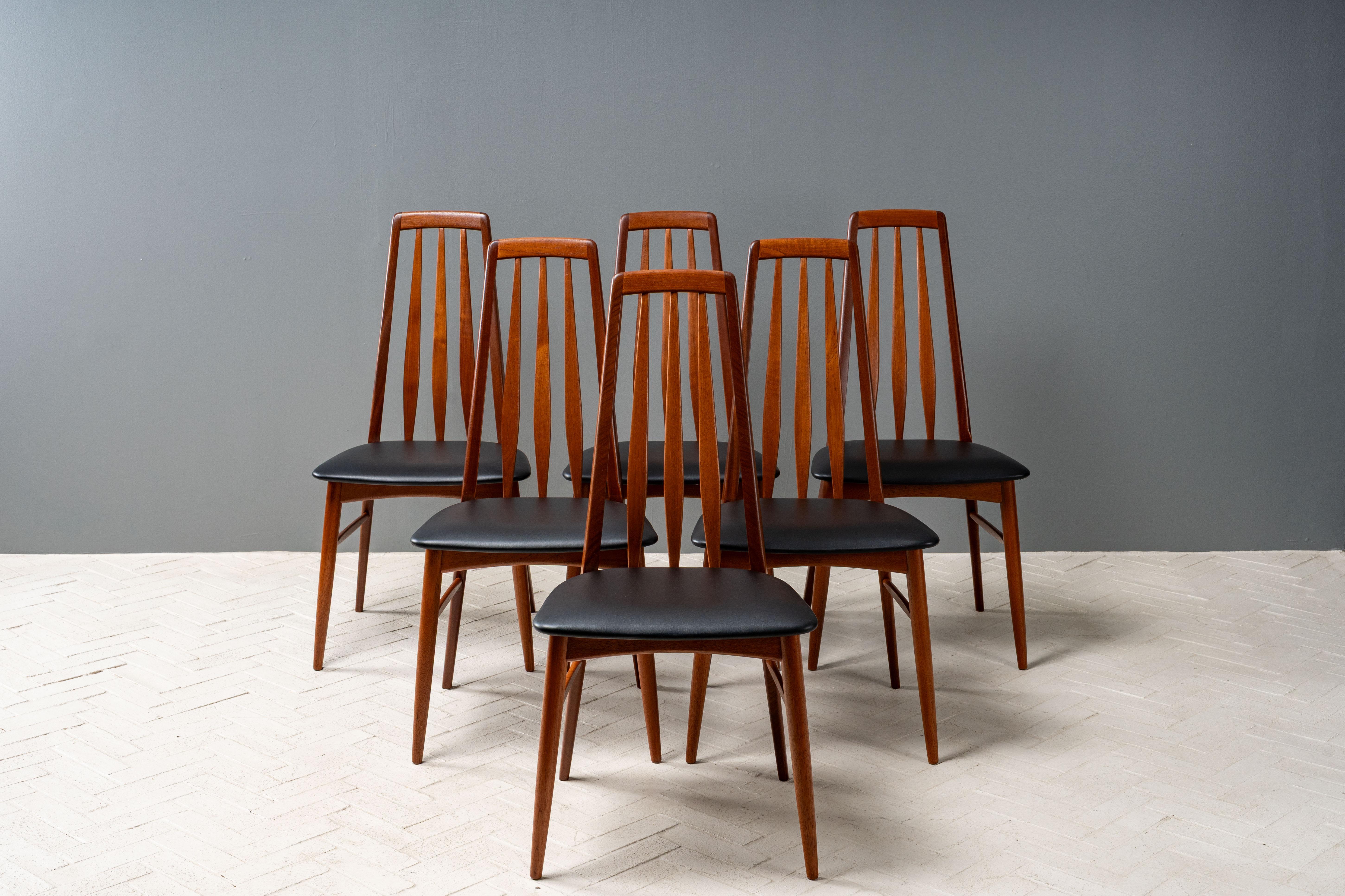 Denmark, ca. 1960s. A set of six teak Eva dining chairs by Niels Koefoed for Koefoeds Hornslet. Each features a high, ergonomic back with flared vertical slats. Sturdy wood frames have been carefully refurbished and are in excellent condition.