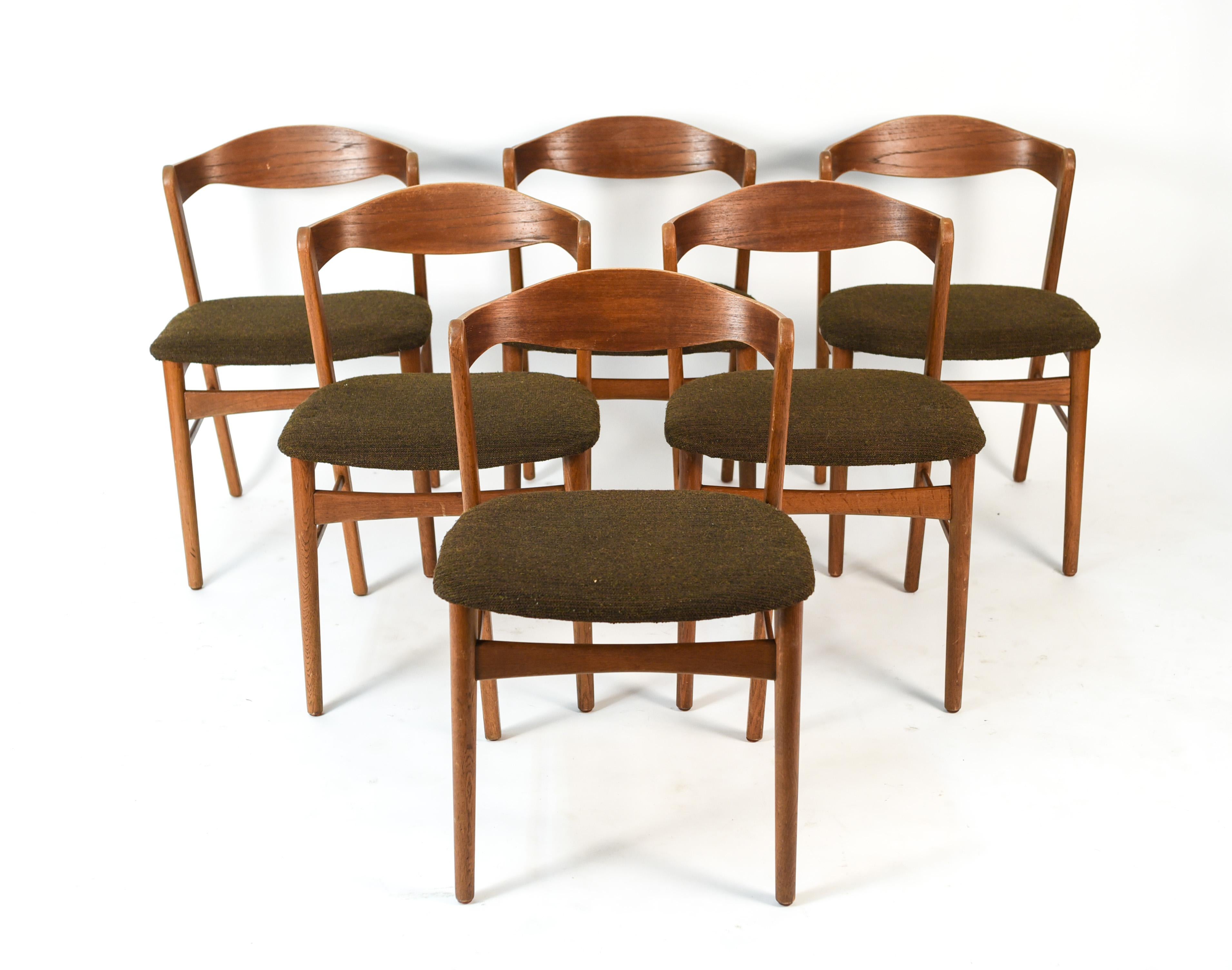 This set of six dining chairs are in the manner of iconic Danish midcentury designer Kai Kristiansen. These chairs encompass his creative use of angles and curves to create unusual, timeless designs.