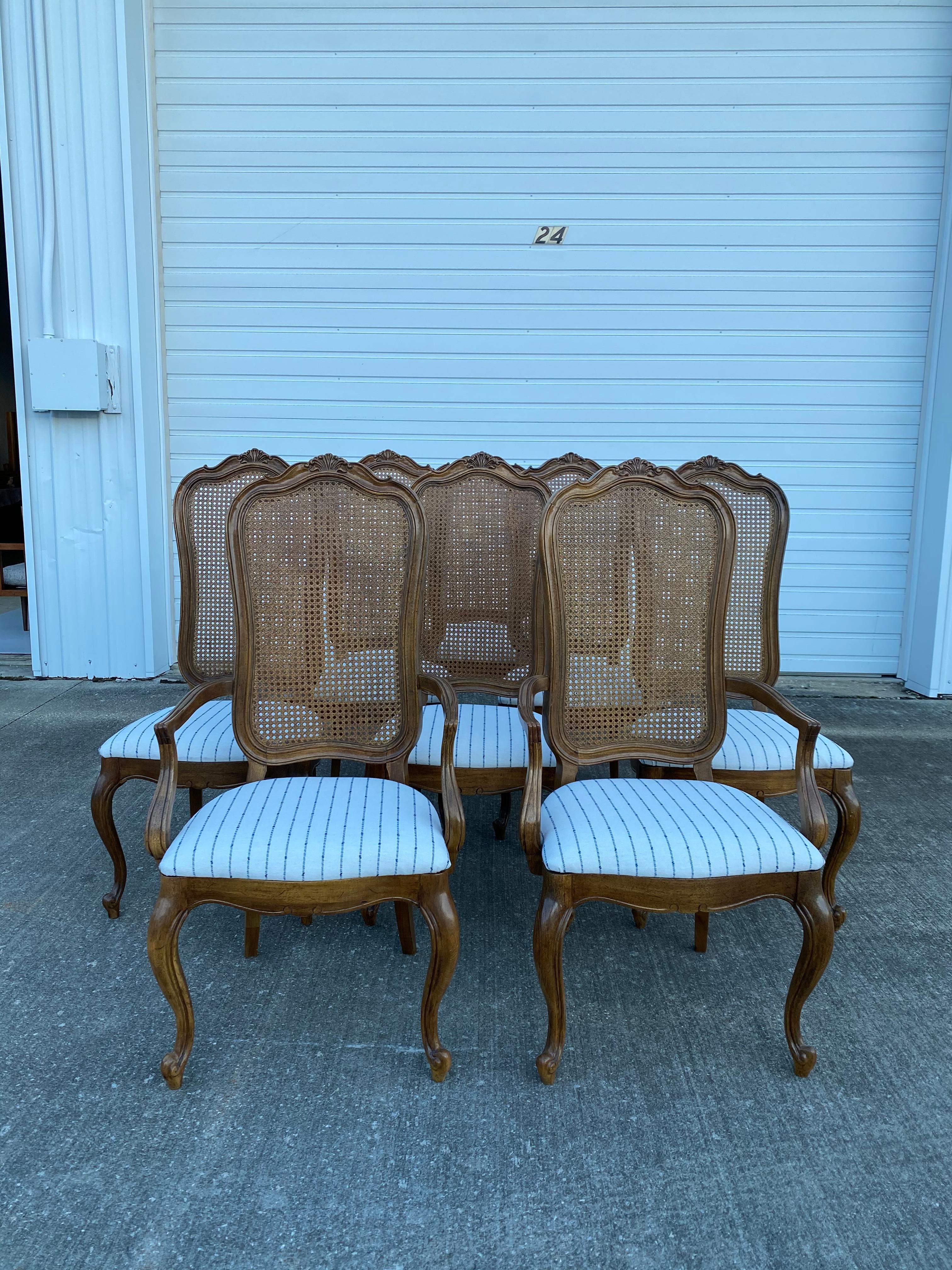 Set of 8 Thomasville French Provincial Cane Back Dining Chairs. 2 armchairs and 6 side chairs included. These chairs are in excellent condition, no breaks in the cane and hardly any scratches or gauges in the wood. These chairs have been