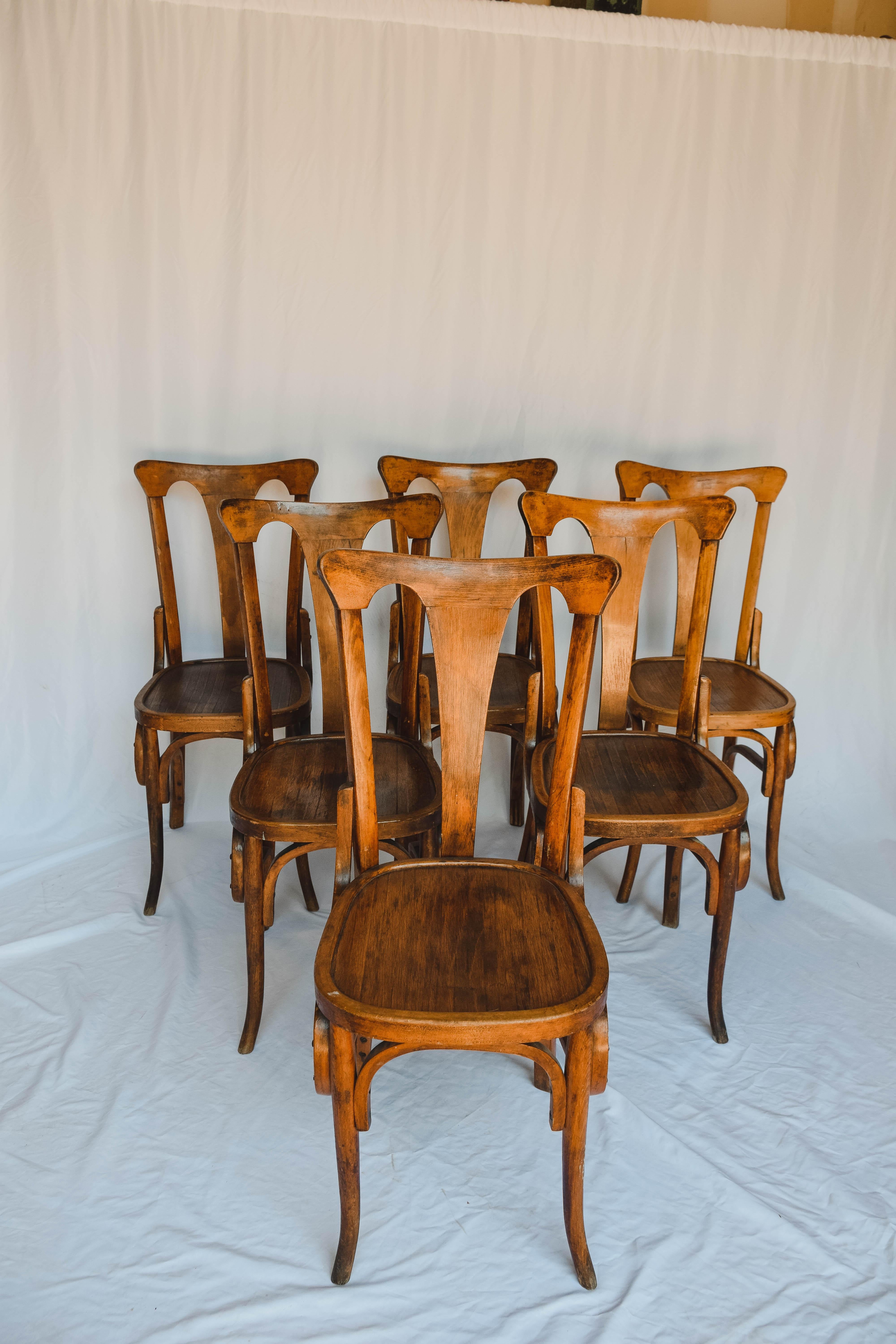 Charming set of 6 Thonet style bistro chairs with bentwood frames. Slatted wood seat. In overall good condition with normal wear. Priced for the set. 20th Century.