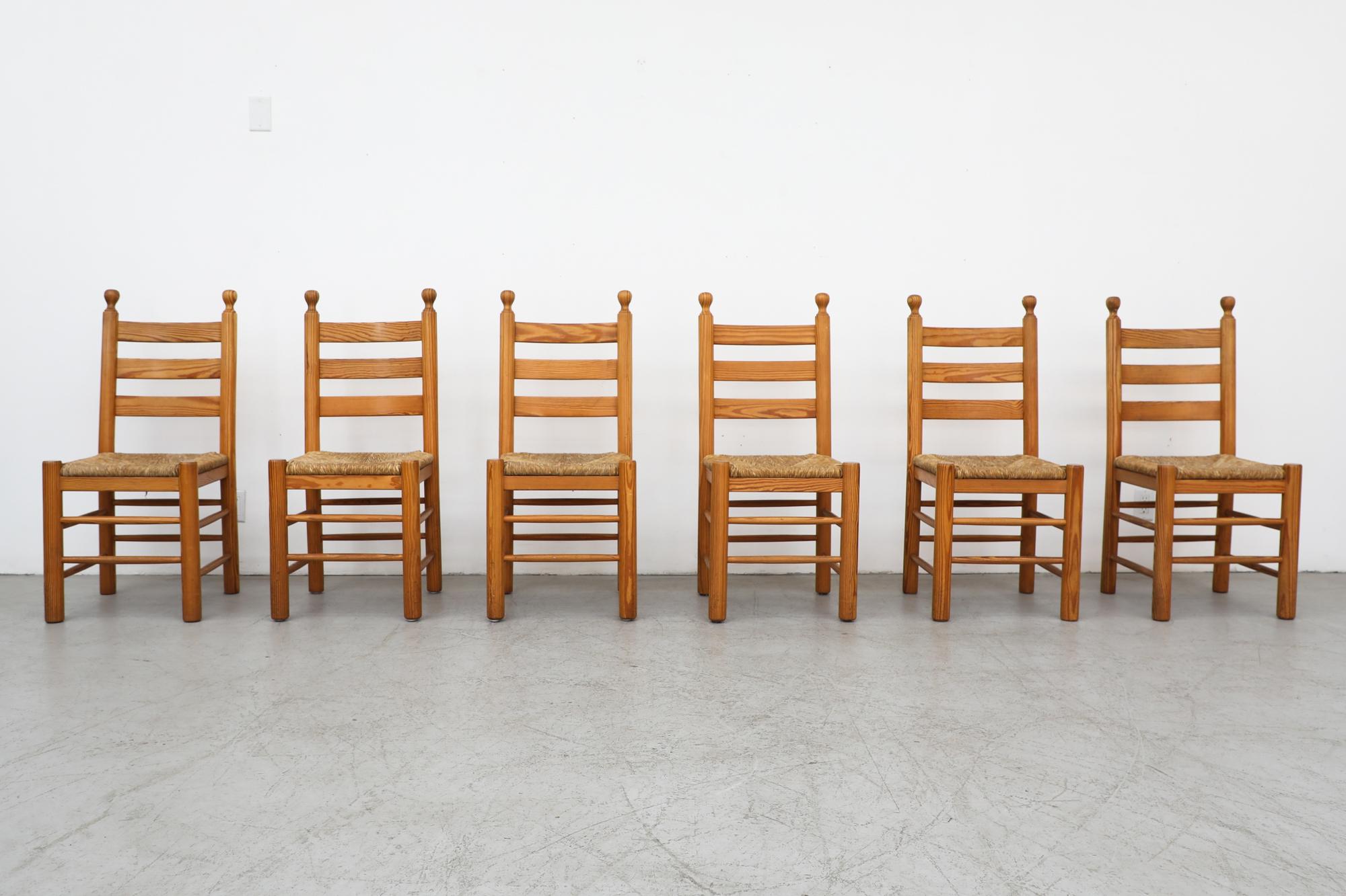 Set of 6 Charlotte Perriand Inspired throne-like pine and rush dining chairs. In original condition, with visible patina and heavy wear, including some breakage and loss to rush seats. Wear is consistent with age and use.