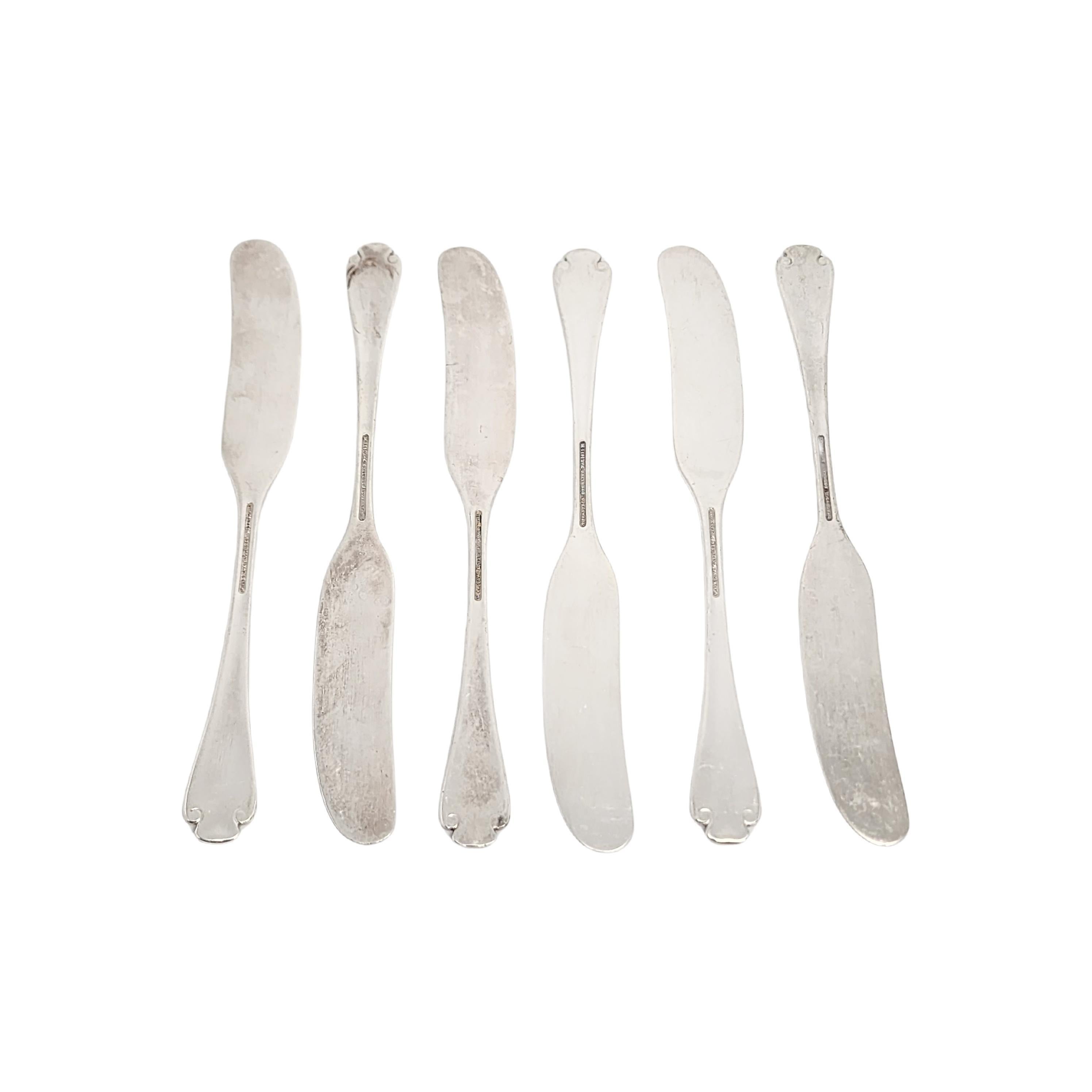Set of 6 sterling silver flat handle butter spreaders by Tiffany & Co in the Flemish pattern.

No monogram.

The Flemish pattern features a simple and elegant scroll design, making it a timeless classic that is still in demand today. Hallmarks date