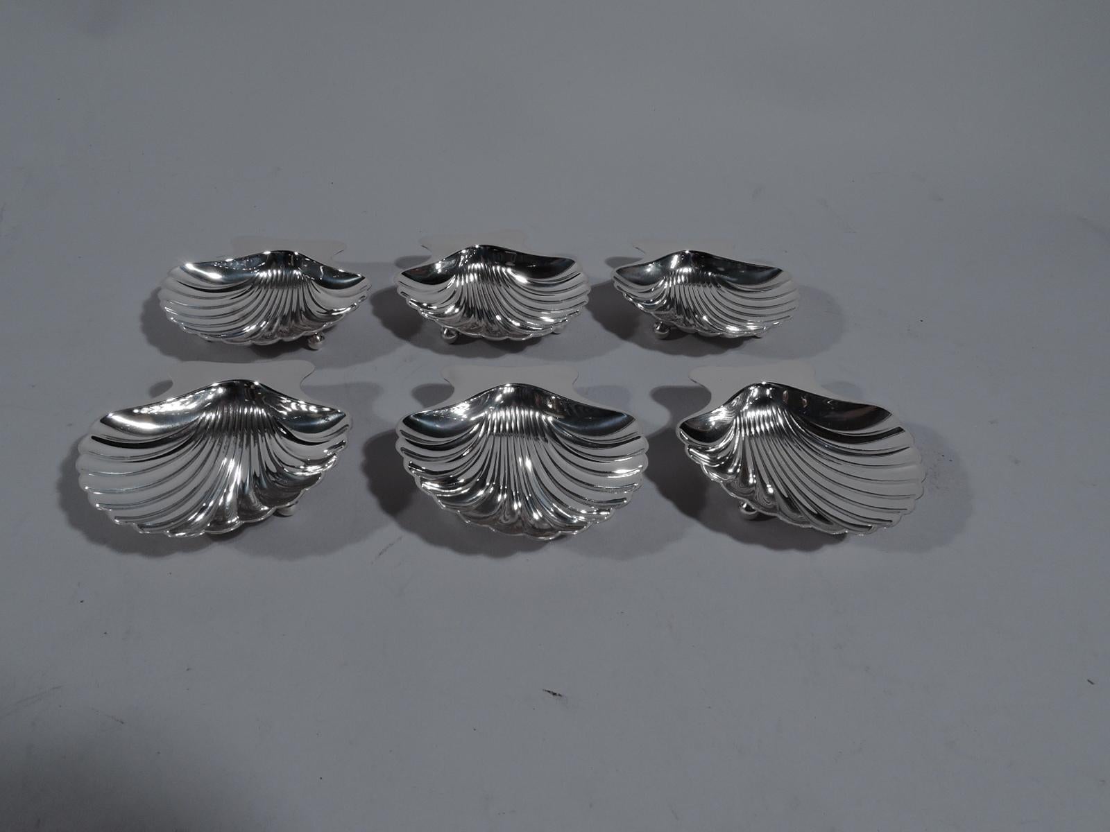 Set of 6 modern Classical sterling silver scallop shell nut dishes. Made by Tiffany & Co. in New York. Each: Dense flutes and plain handle. Rests on 2 balls. Fully marked. Total weight: 6.5 troy ounces.