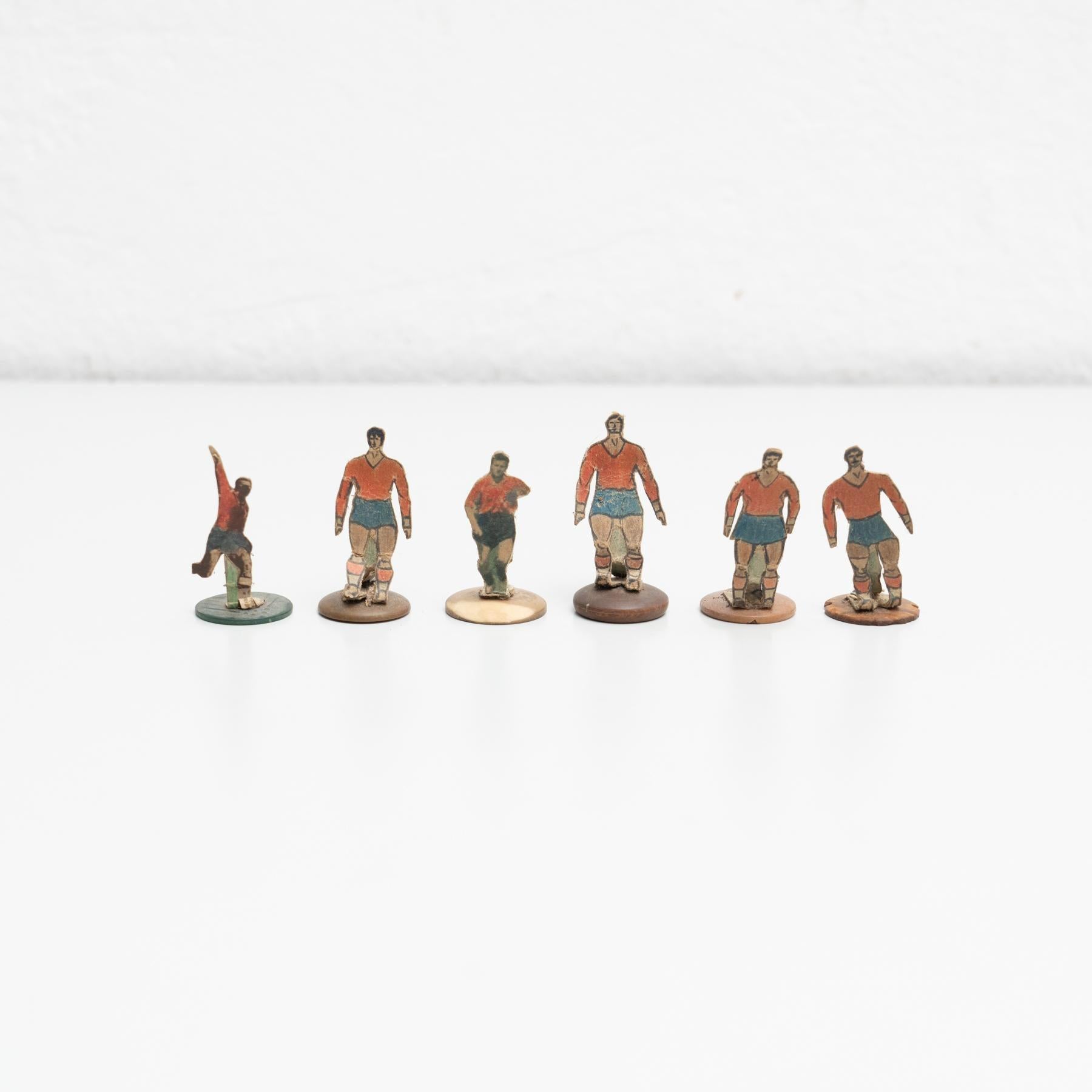 Set of six table button soccer game players. Traditional figures used to play this classic button Spanish game.   The players are build buy attaching a printed photography or drawing of an actual football soccer player to a clothing button.  
