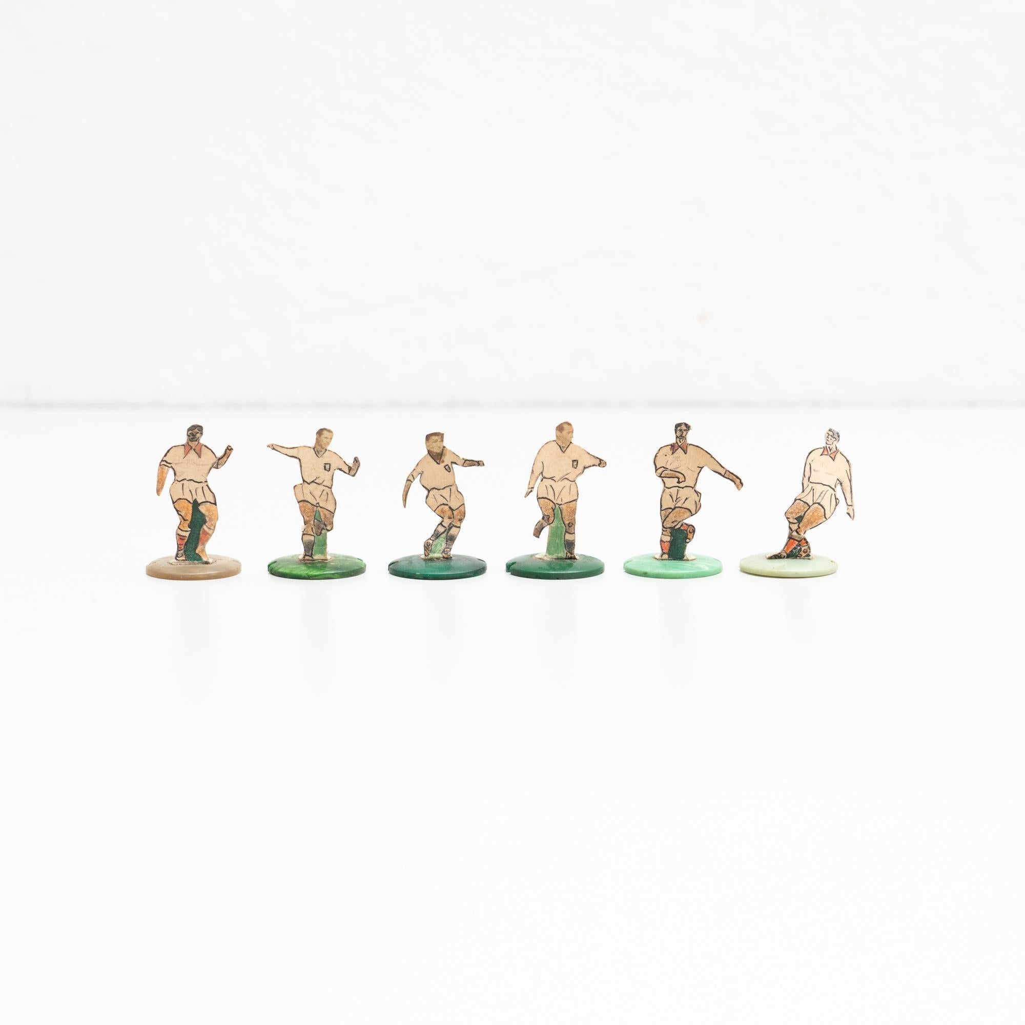 Set of six table button soccer game players. Traditional figures used to play this classic button Spanish game.     The players are build buy attaching a printed photography or drawing of an actual football soccer player to a clothing button.    