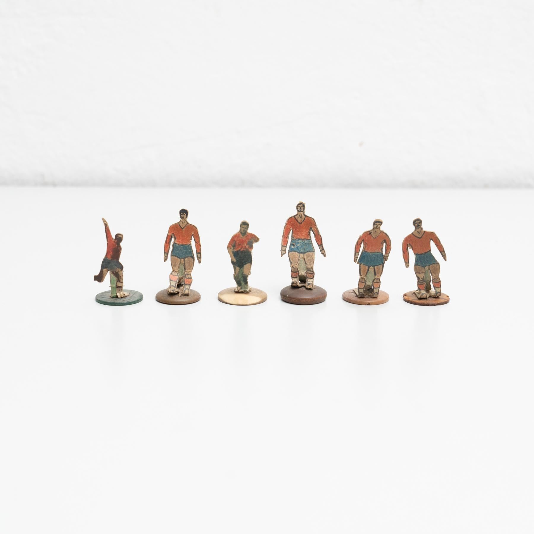 Set of six table button soccer game players. Traditional figures used to play this classic button Spanish game. 

The players are build buy attaching a printed photography or drawing of an actual football soccer player to a clothing button.