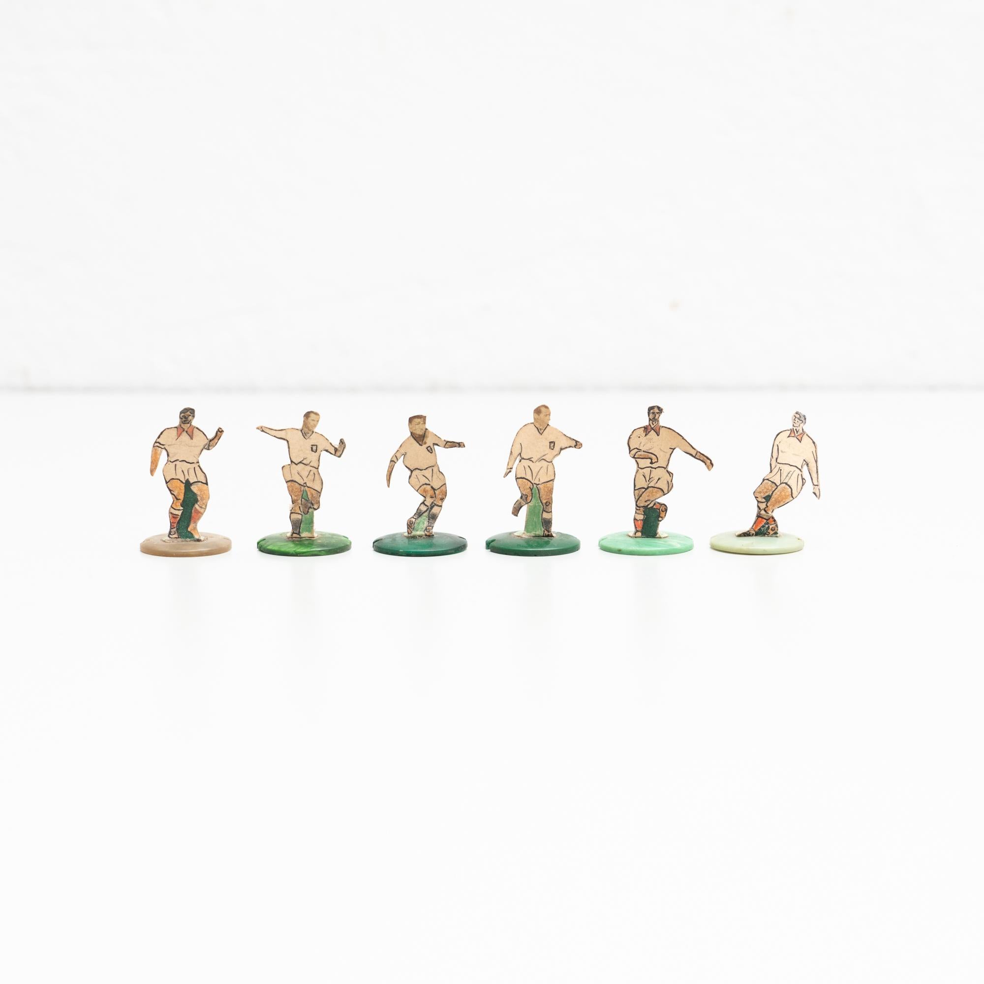 Set of six table button soccer game players. Traditional figures used to play this classic button Spanish game. 

The players are build buy attaching a printed photography or drawing of an actual football soccer player to a clothing button.