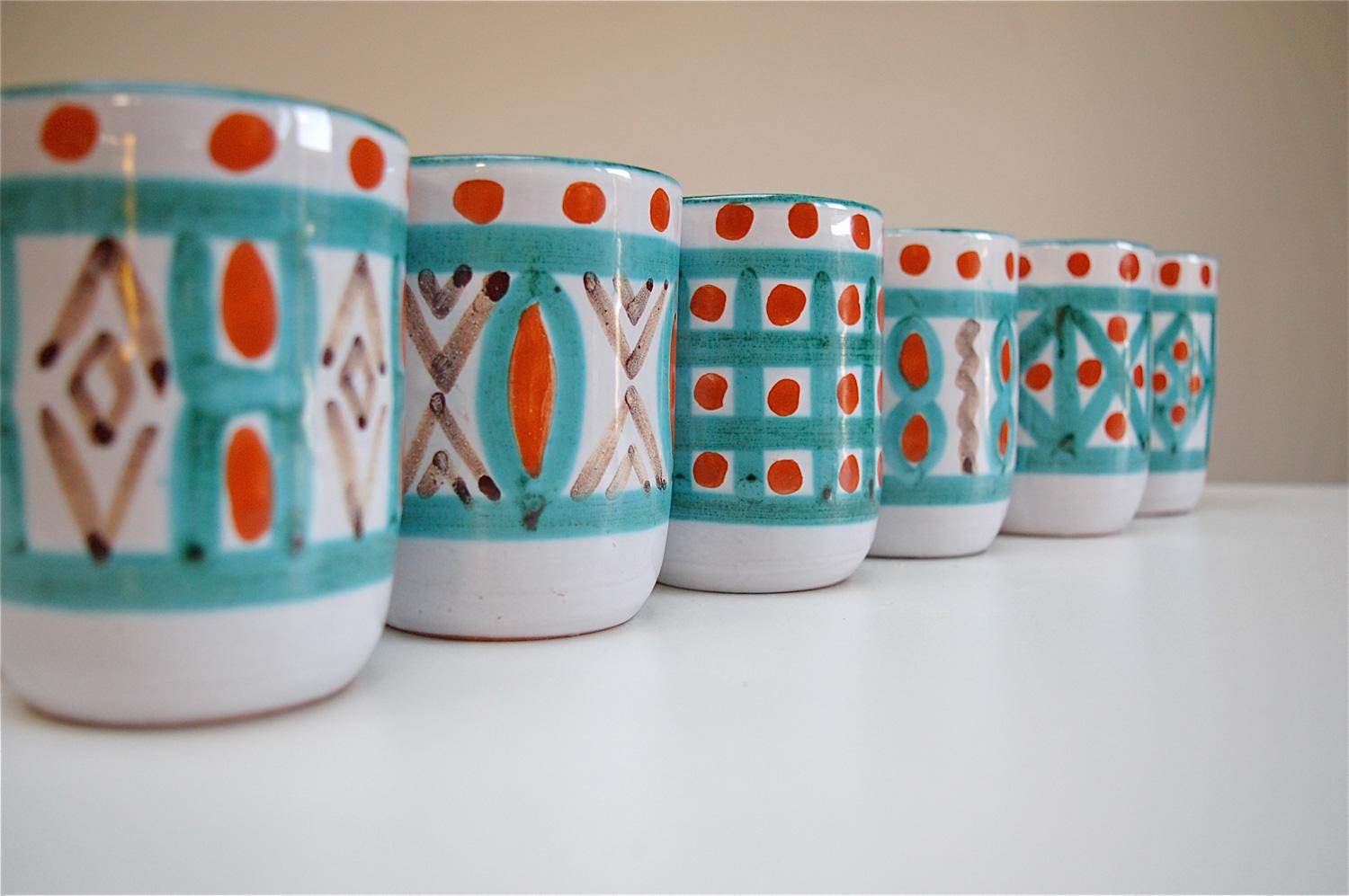 Set of six handmade vintage mugs by Antoine Fazio in the well-known pottery town of Vallauris in the South of France. Dipped in a white glaze as a base color, each mug was then decorated by hand with an individual design consisting predominately out
