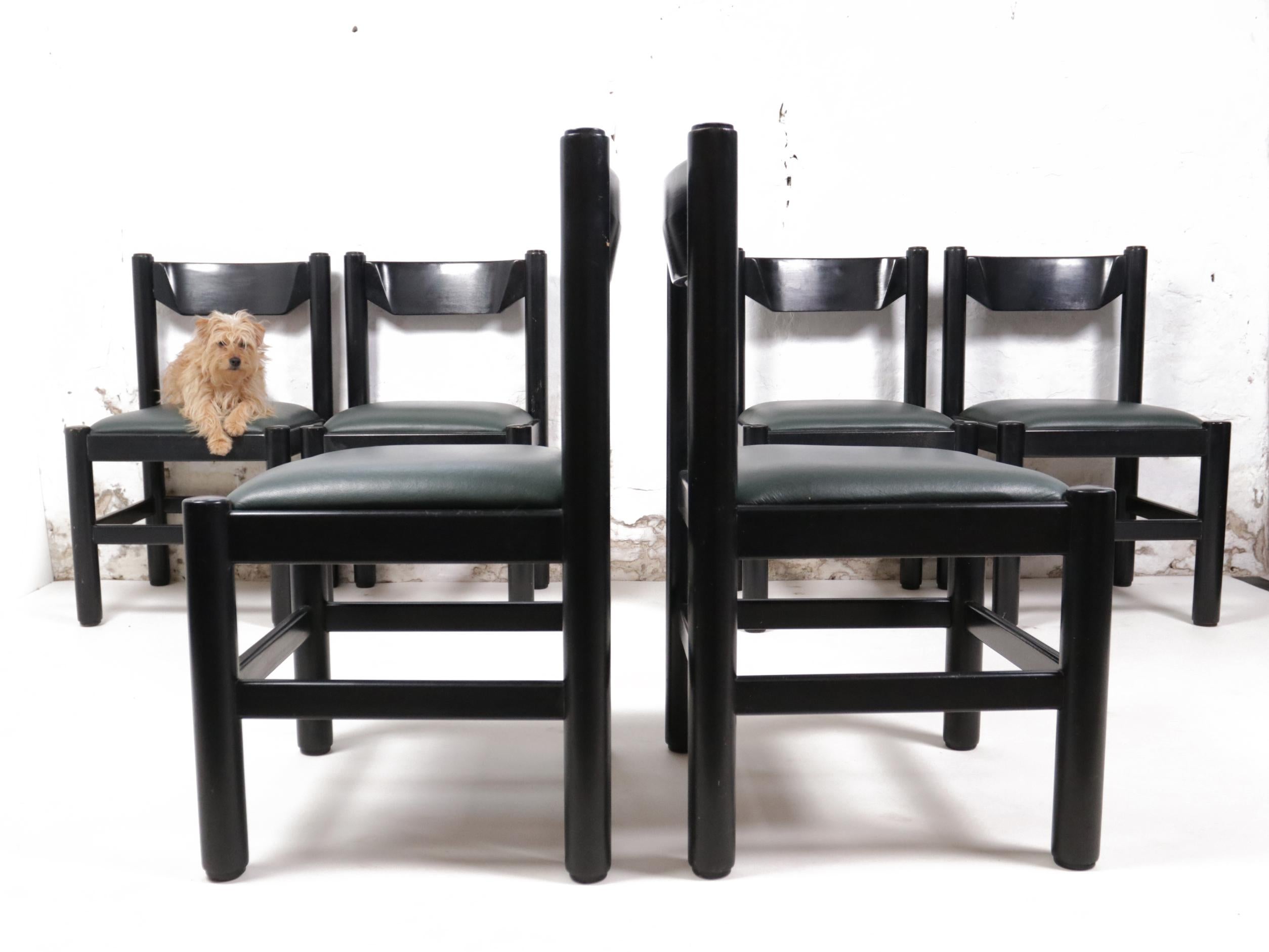 Beautiful design dining room chairs dating from the ‘70s.
These chairs are often attributed to Vico Magistretti, produced by Cassina, made in Italy. 
Made of solid black coated wood. The seats are made of leather.


