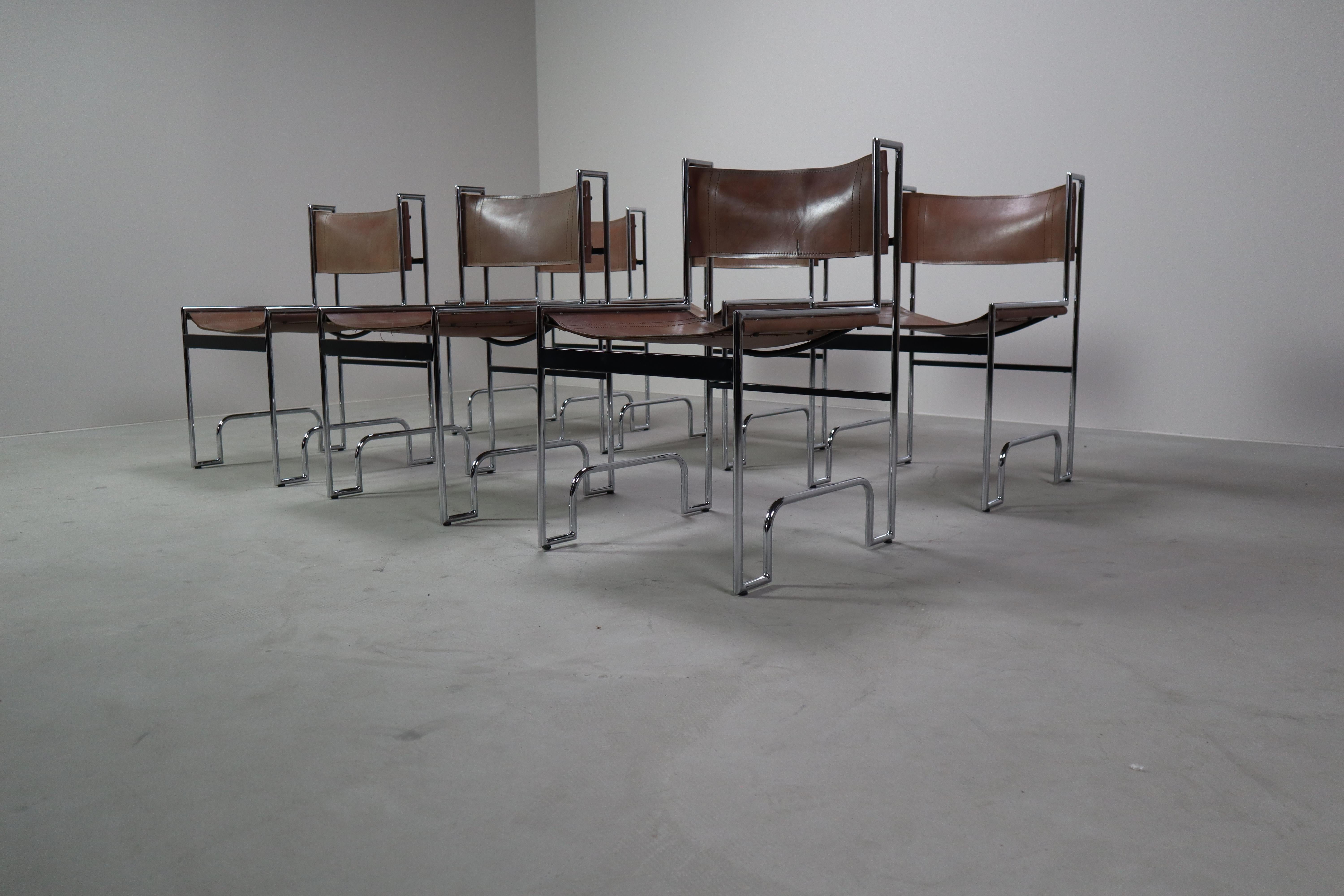 Elevate your interior with this striking set of six vintage dining chairs, showcasing a bold Bauhaus-inspired design. These chairs feature a sleek tubular chrome frame paired with natural leather for the seat and backrest — both aged beautifully