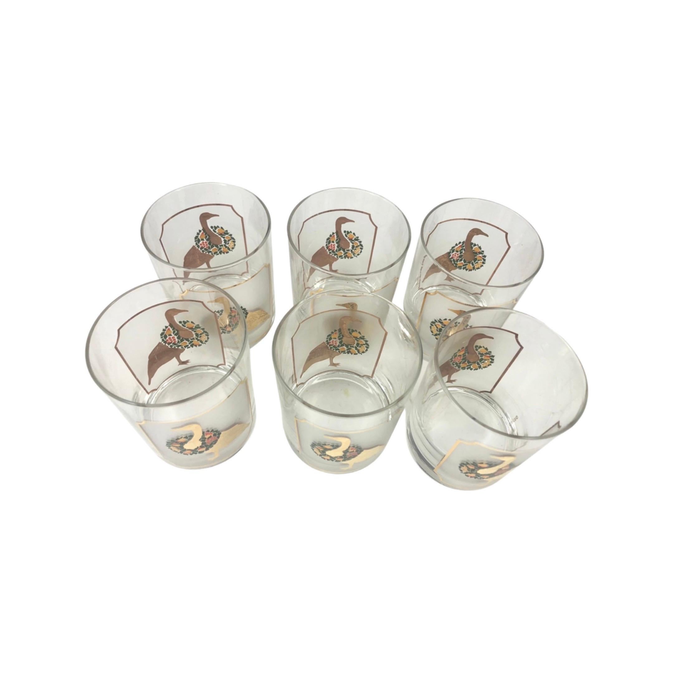 Set of 6 Vintage Culver Festive GeeseOld Fashioned Glasses. Each glass with 2 gold geese adorned with a festive and colorful wreath of various fruits on a frosted background framed in a 22k outline.
Signed Culver on the side. All in excellent