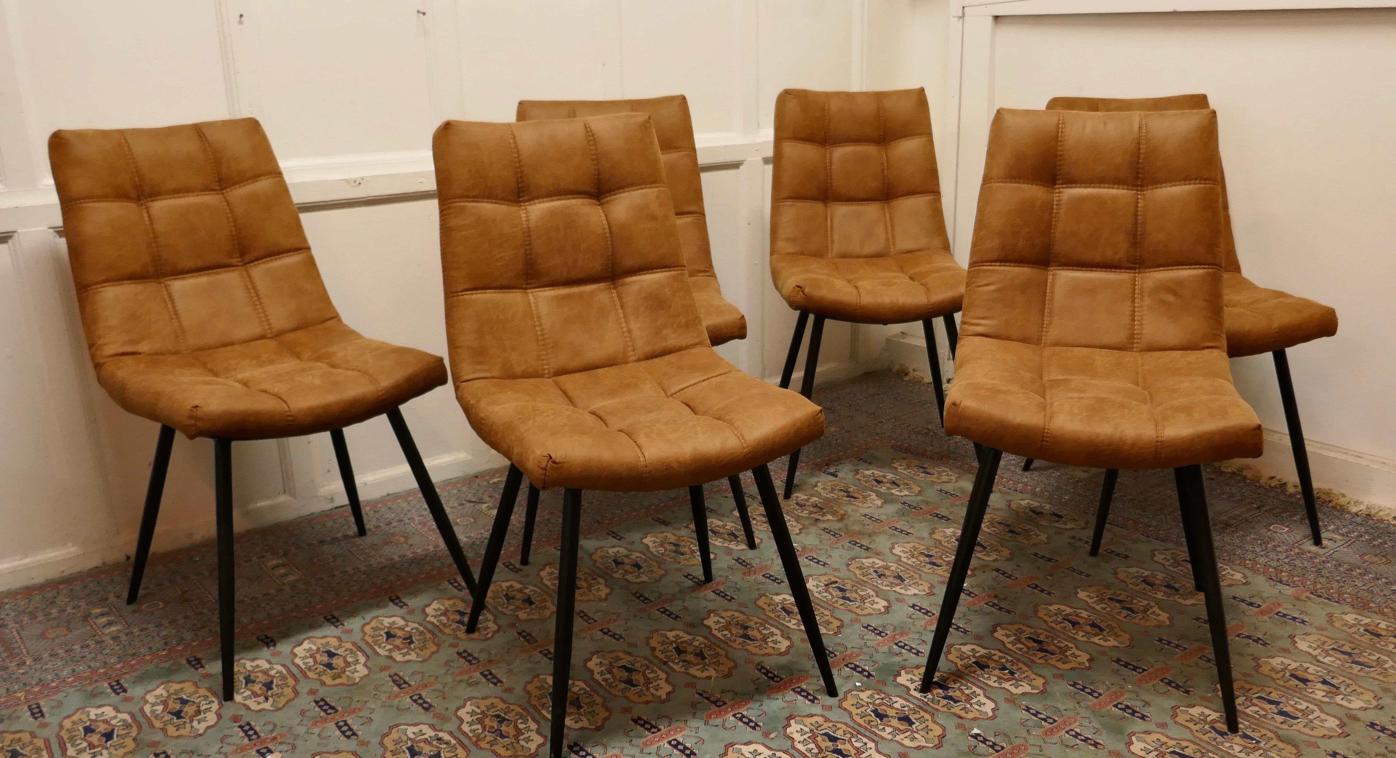 Set of 6 Mid Century Dining Chairs Upholstered in Suede 

The chairs are upholstered in stylish buff brown Nubuck which is double stitched in a padded square pattern, they have black steel hairpin style legs 
This superb quality and very comfortable