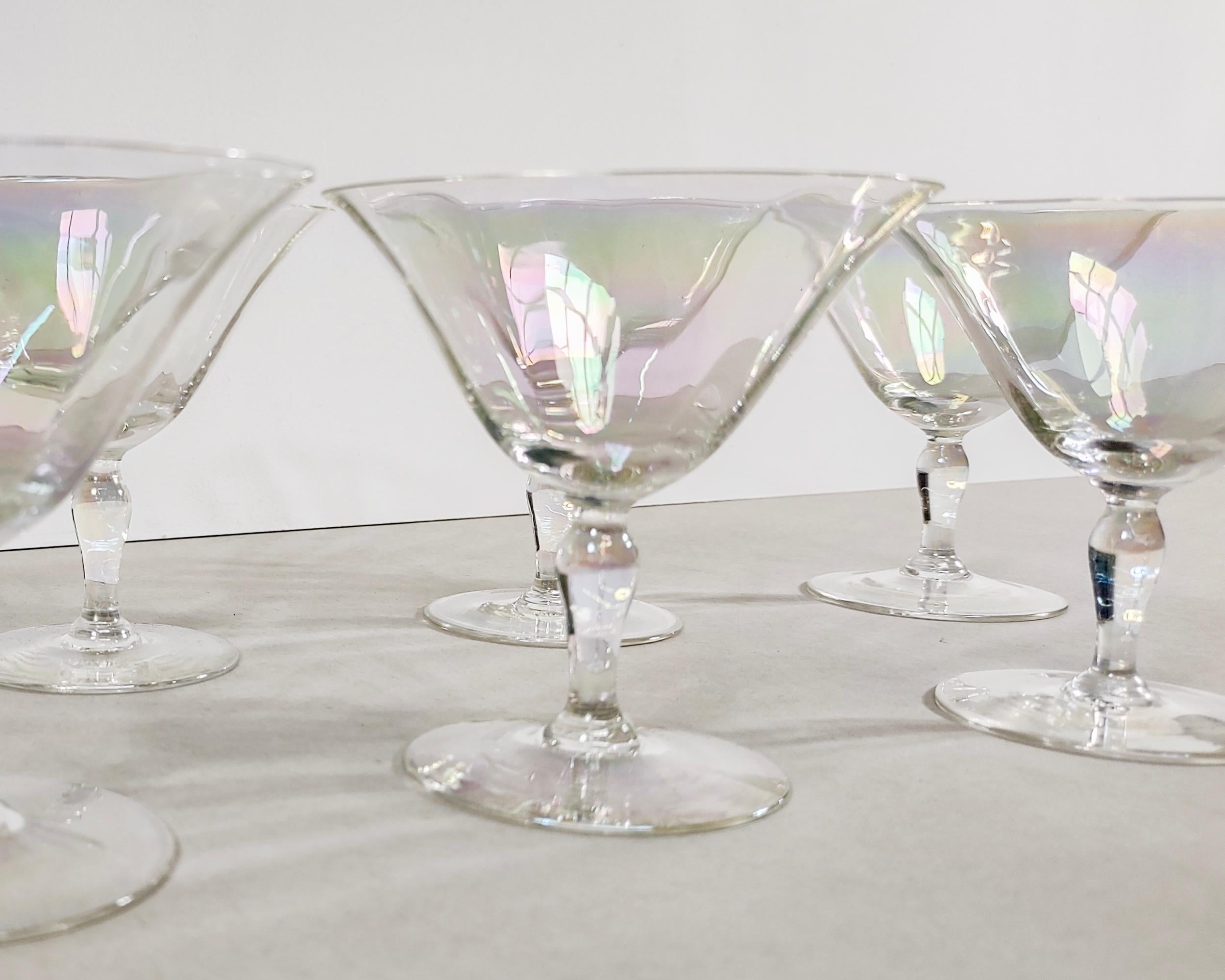 Set of six vintage 'Mother of Pearl' delicate iridescent tulip-shaped coupe champagne glasses by Fostoria circa 1930. Flared thin rims and hourglass shaped stems. Hand blown glass. Overall excellent condition, no chips or cracks.

4