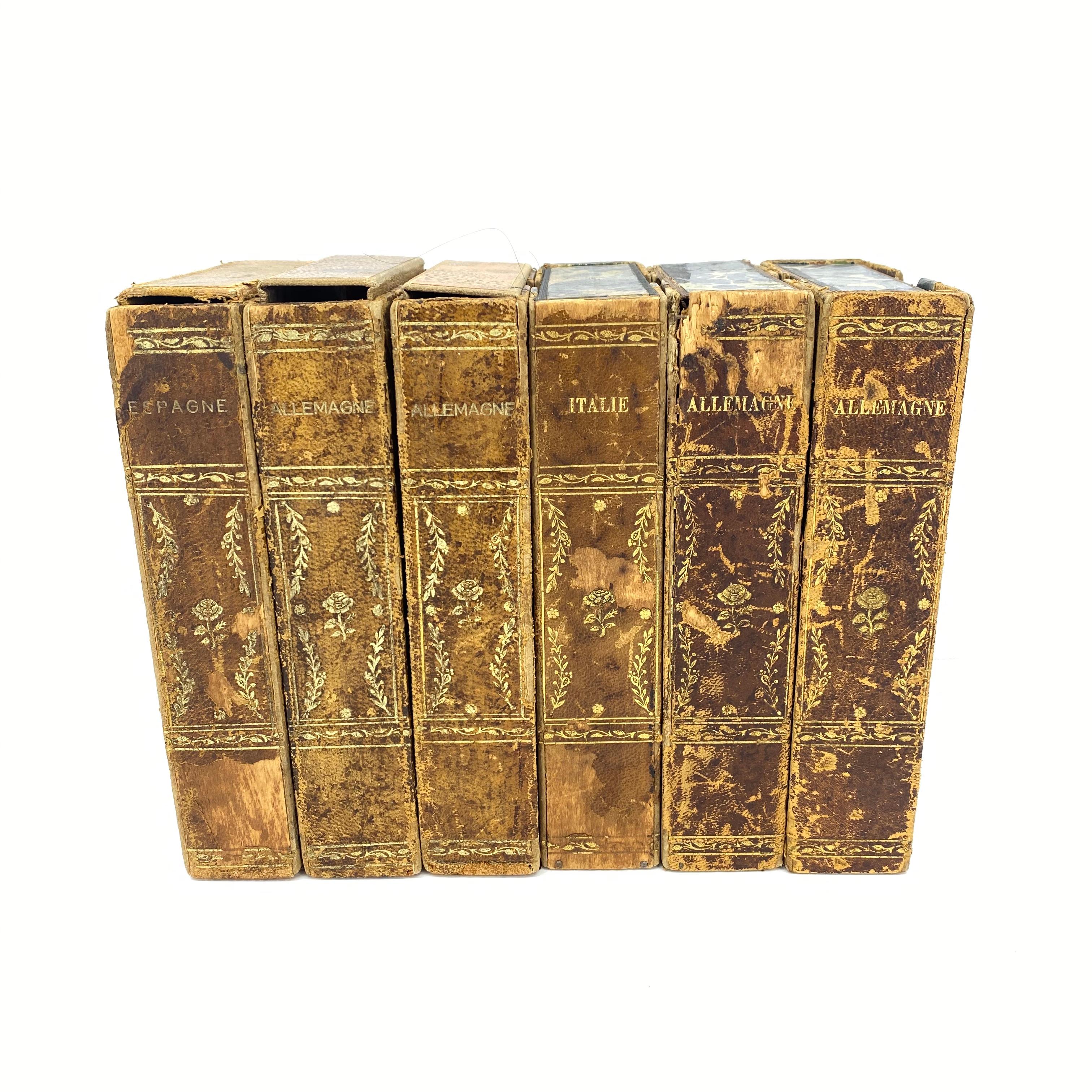 2 sets of 3 vintage leather-backed book boxes

This set consists of two sets of 3 book boxes. One set has the box-sides made in colorful blue faux marbled paper on board, the other 3 books in brown faux marbled paper.

Each book measures depth
