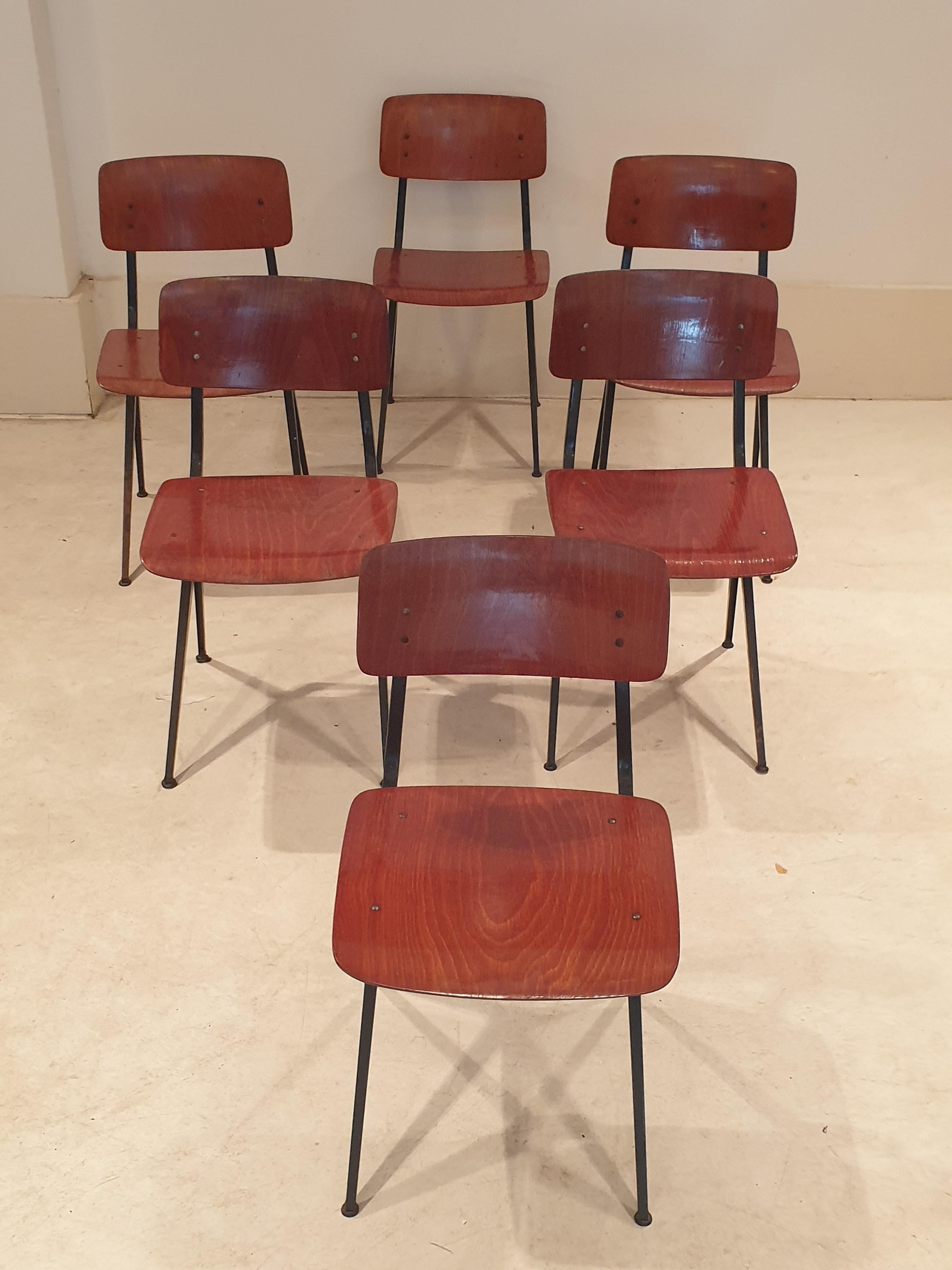 Set of six industrial style chairs by Marko Holland. This comfortable utilitarian chairs have beautiful aged teak seats and backs and black lacquered metal minimalist frames. Their simplicity mean they would fit into any decorative scheme and their