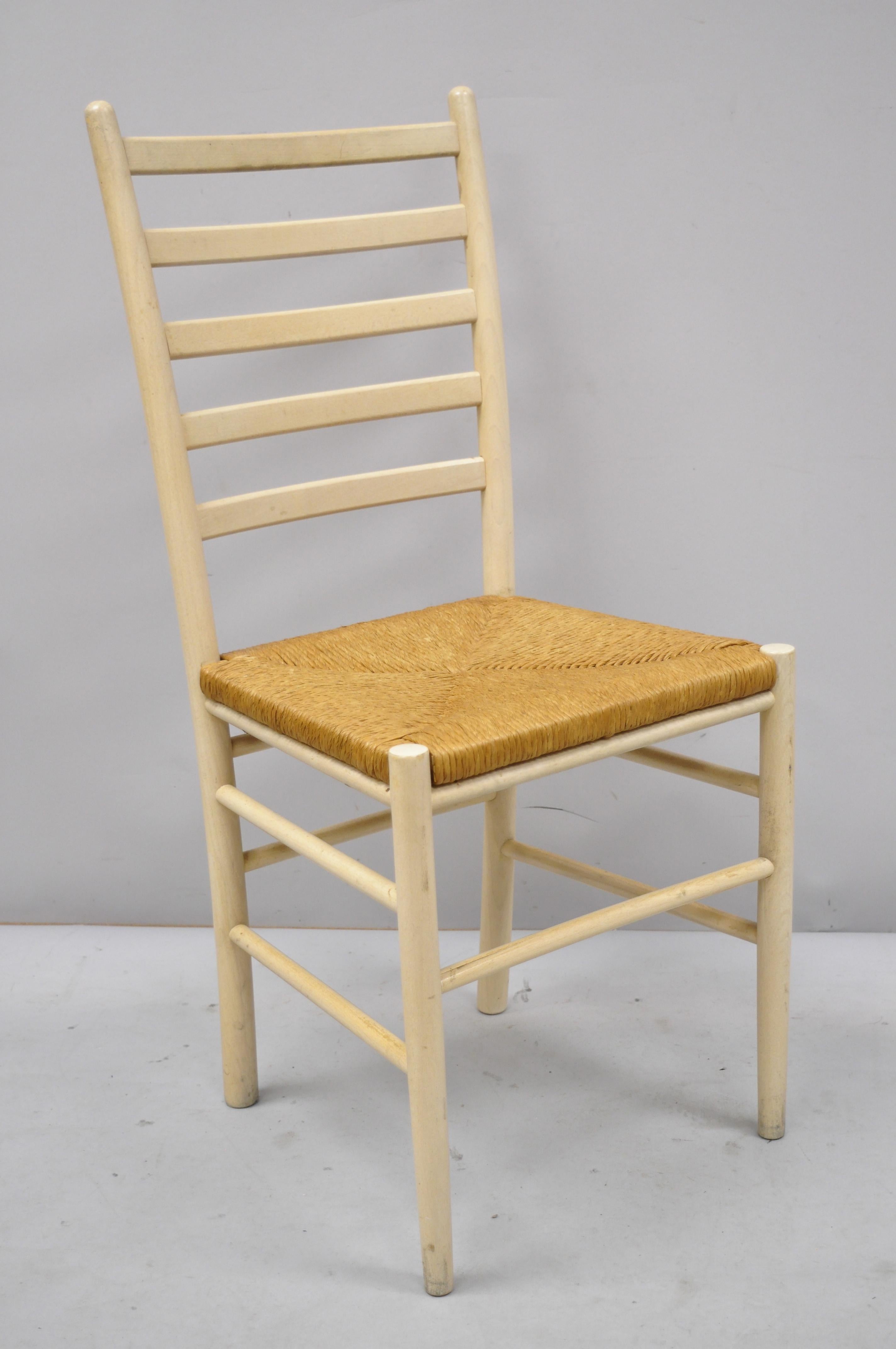 Set of 6 vintage midcentury Italian modern ladder back rush seat dining chairs. Listing includes (6) side chairs, woven rope seats, sleek ladder backs, solid wood frame, circa mid-late 20th century. Measurements: 37