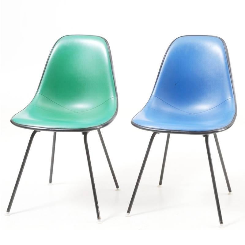 Set of 6 1970's Vintage Herman Miller Eames Shell chairs in an array of colors.  Chairs feature a black fiberglass shell base with vinyl covers in; red, blue, green, purple, orange, and pink.  This set represents a wonderful selection of colors and
