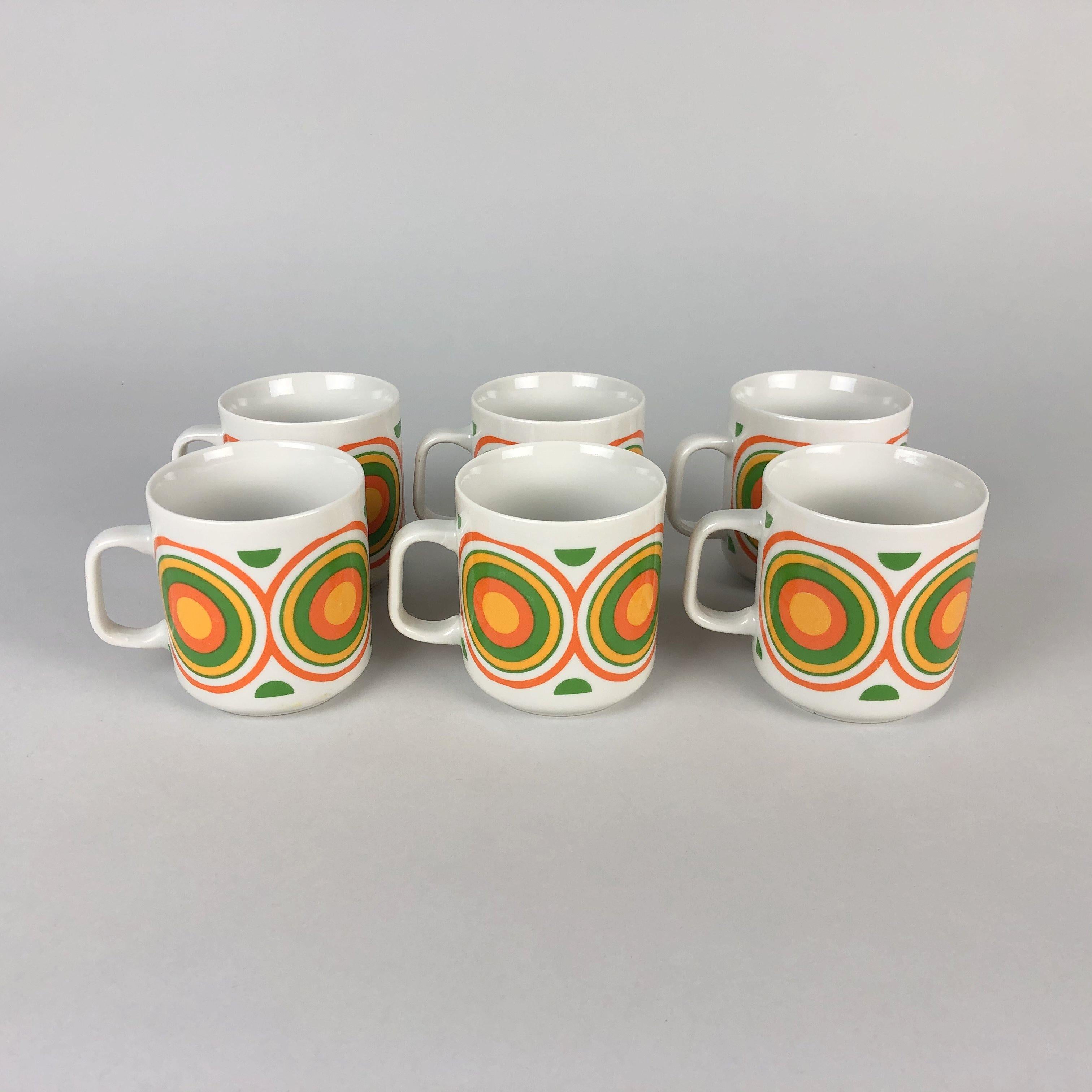 Set of six colourful mugs with circle pattern. Glazed ceramic mugs made in Poland by Lubiana in the 1970s.
 