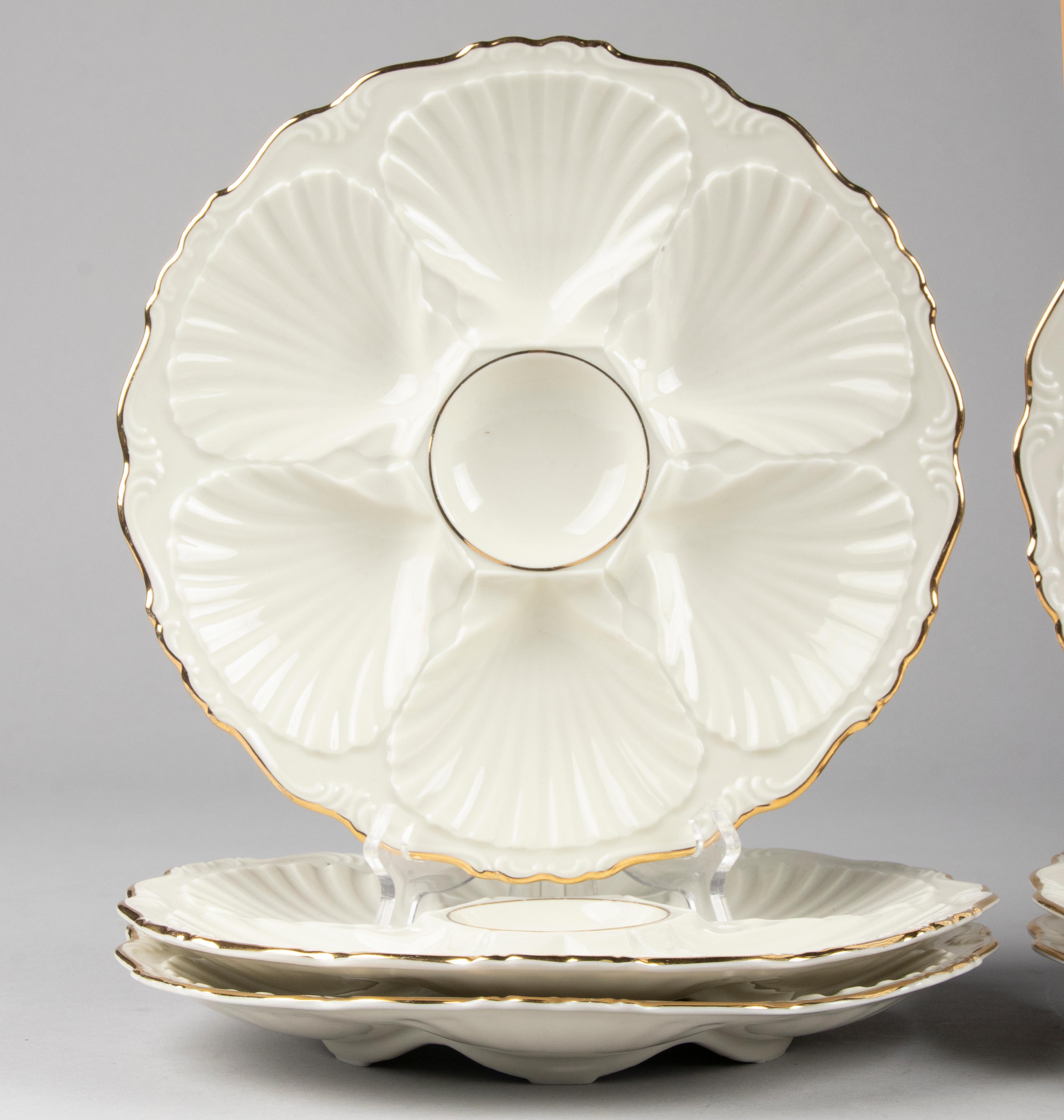 Set of 6 porcelain oyster plates from the German brand Edelstein Bavaria. The plates are ivory colored and have gold colored edges. The plates are decorated with a shell pattern in relief. All plates are marked on the bottom. The plates are in good
