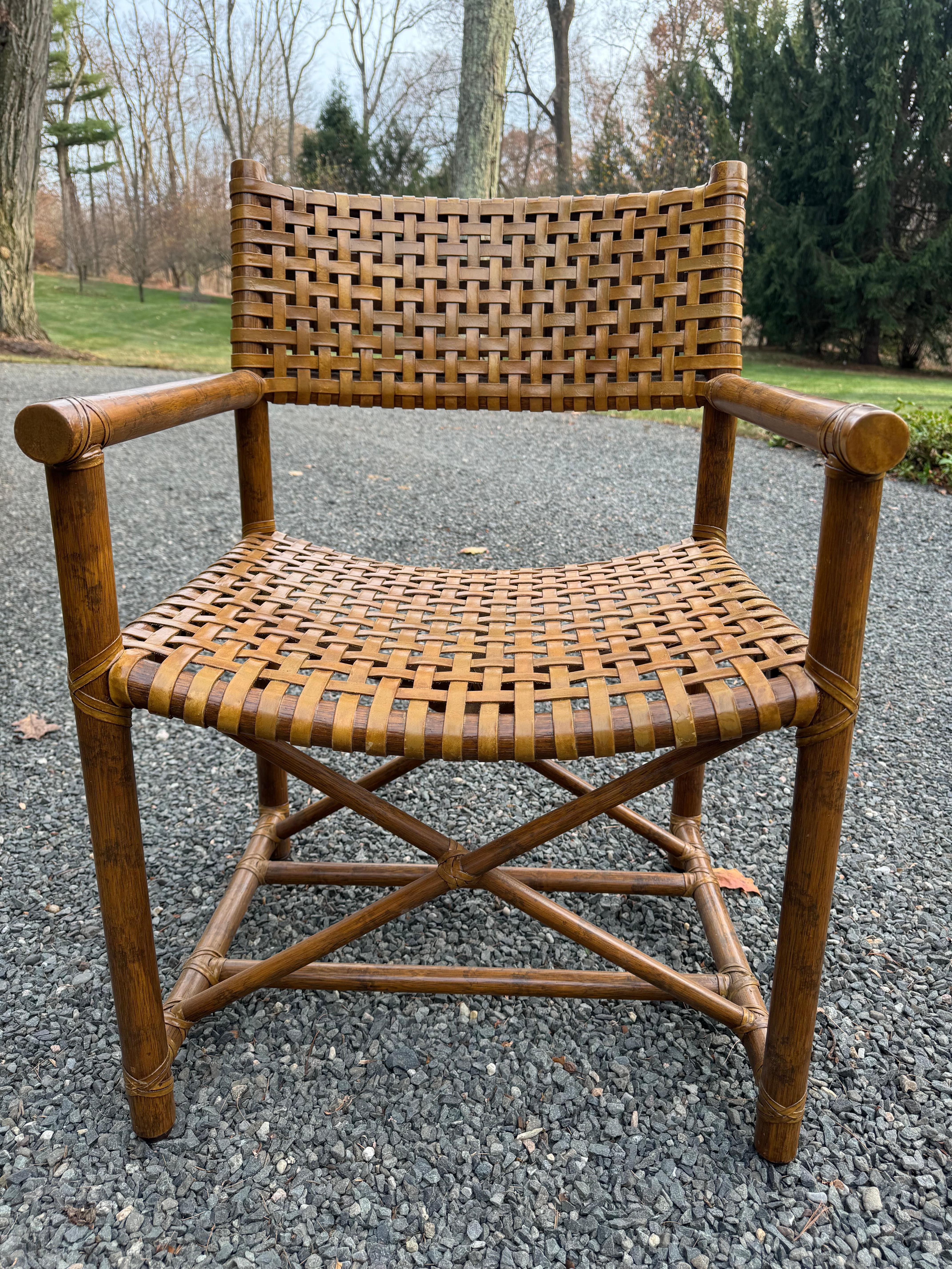 Set of 6 iconic McGuire Antalya laced rawhide and rattan dining chairs .  The frames have a director’s chair style with an X form stretcher.  A dark tobacco finish and aged patina makes them masculine and timeless.  McGuire tags are on underside of