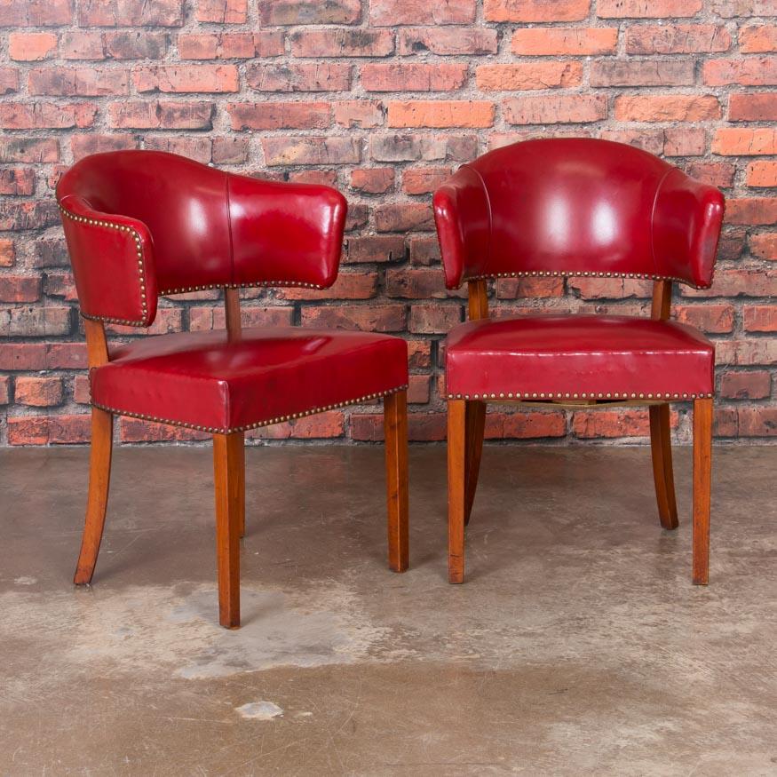 Fabulous both visually and to sit in, this wonderful set of 6 barrel back side chairs is a great find. The vintage red leather (which is in very good condition for its age) is complimented with brass studs, while the curved barrel back and clean