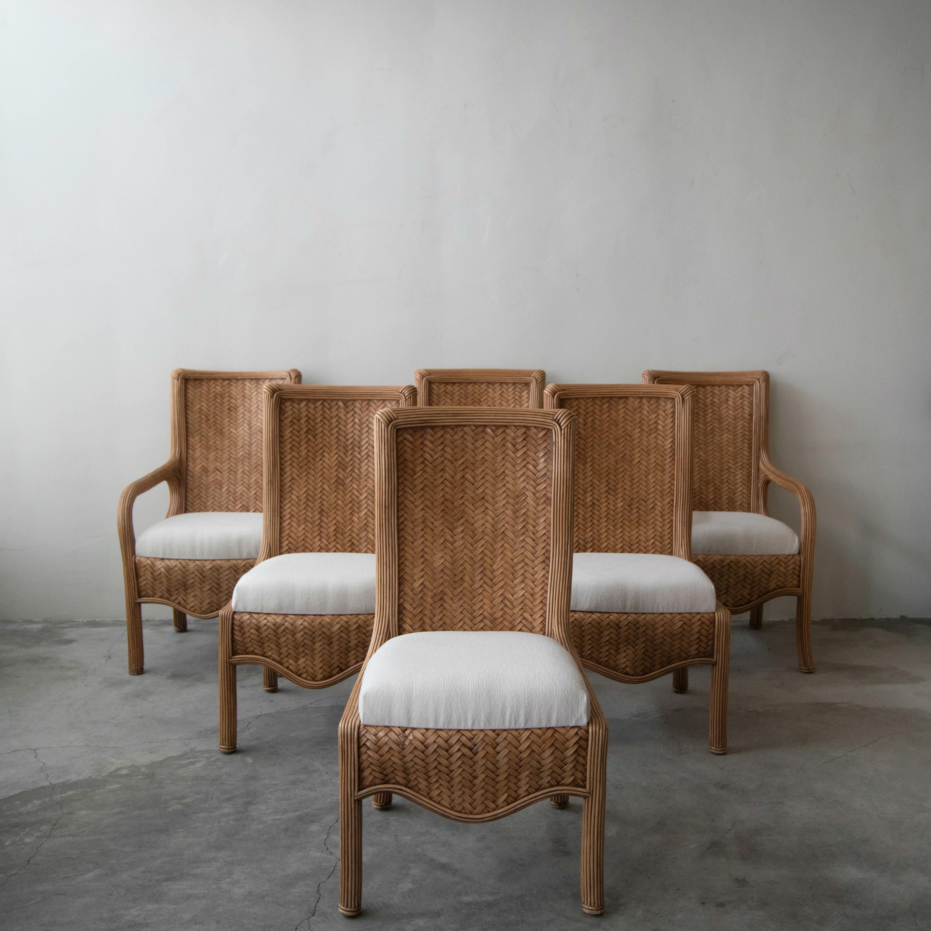 1980s vintage, reeded bamboo dining chairs. Part of the Linea Cara Collection by Karl Rausch for Baker. Chairs feature beautiful natural reeded bamboo and basketwoven rattan backs, the seats are upholstered in a softly textured off white