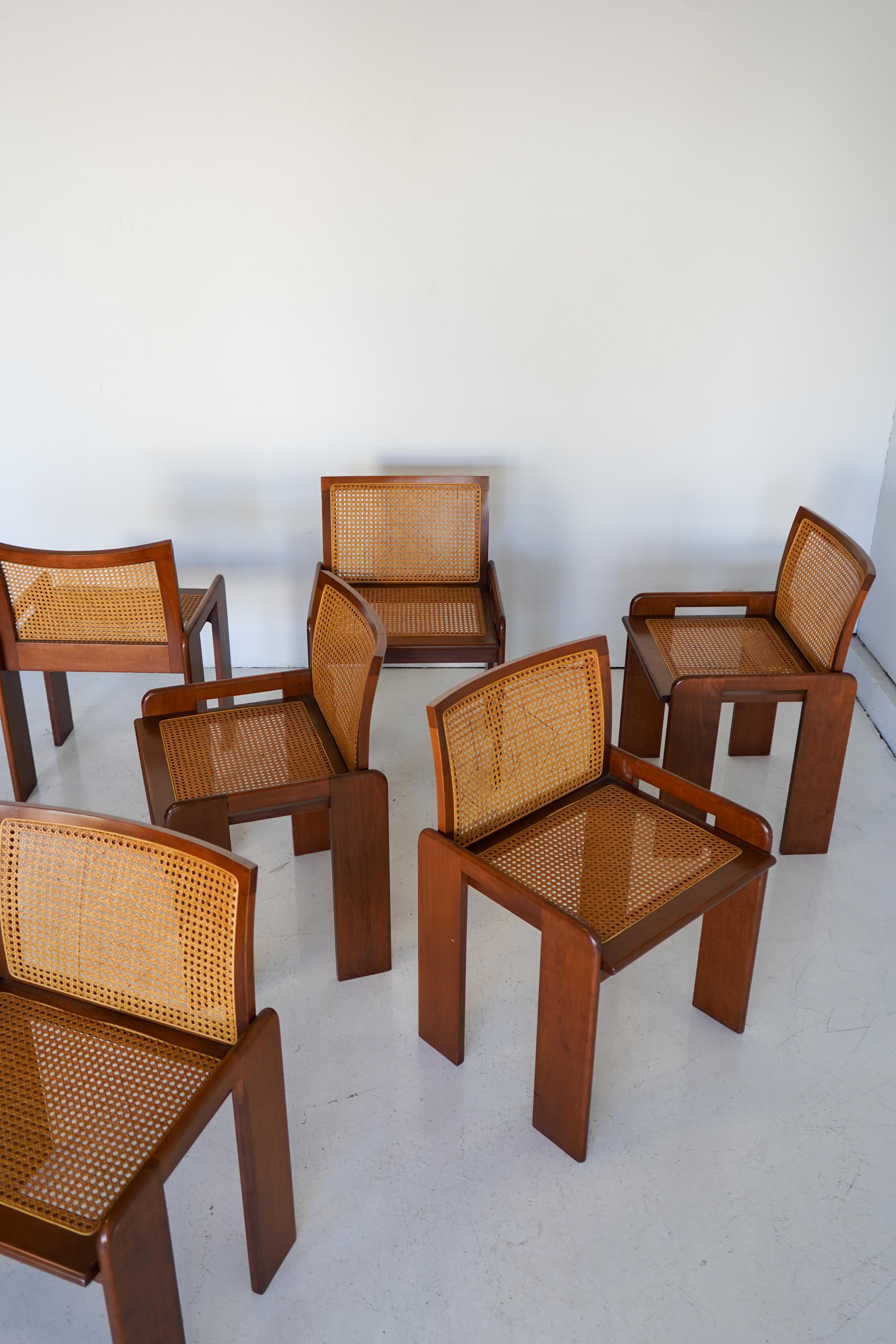 Set of 6 dining chairs by Italian designer Luigi Saccardo, 1970s.

Walnut frames with soft, curved backs and hand-woven cane seats and backrests. 

In very good condition. Sold as a set.

