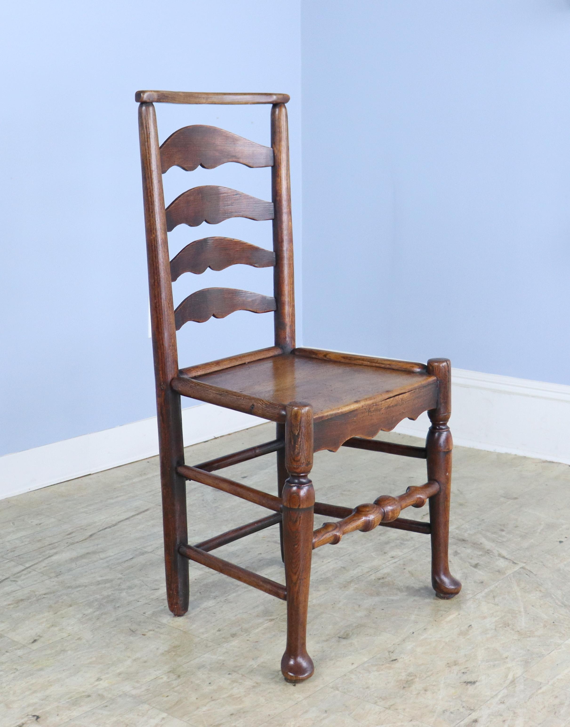 A set of 6 early Welsh dining chairs with charming ladderbacks and pad feet. Mid 18th Century and handmade, there are slight variations in each chair, shown in thumbnails.  While the seat height of 17.5
