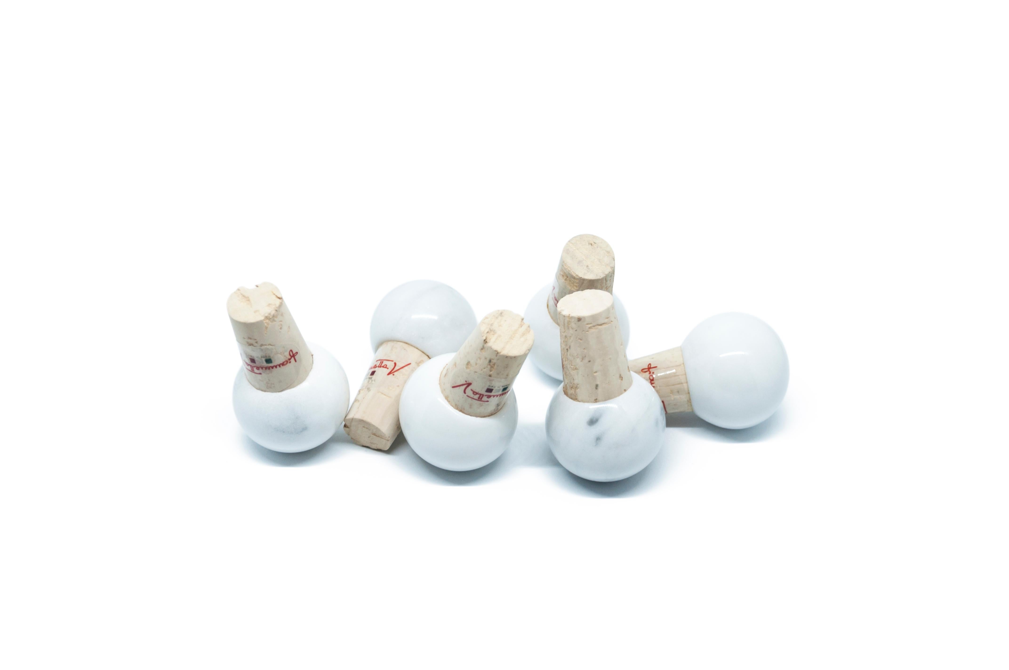 Set of 6 bottle stoppers in white Carrara marble and cork, ideal for wine and olive oil glass bottles.

Each piece is in a way unique (since each marble block is different in veins and shades) and handcrafted in Italy. Slight variations in shape,