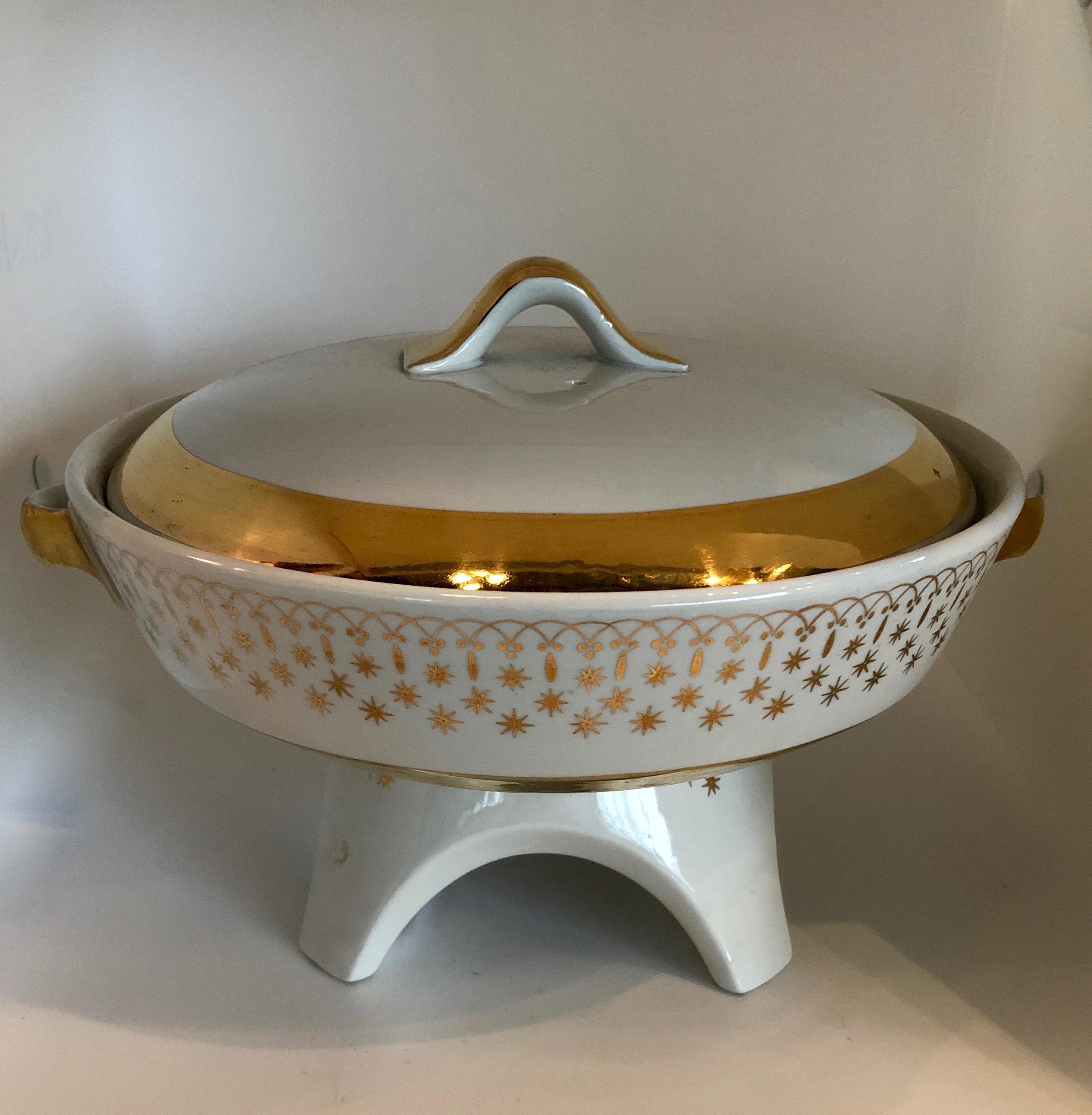 Offered is a Mid-Century Modern beyond gorgeous white and gold gilded porcelain fondue pot and six bowls (outer of gold and inner white) from Pickard and Hall China. The set of six bowls are bone china that has been 
