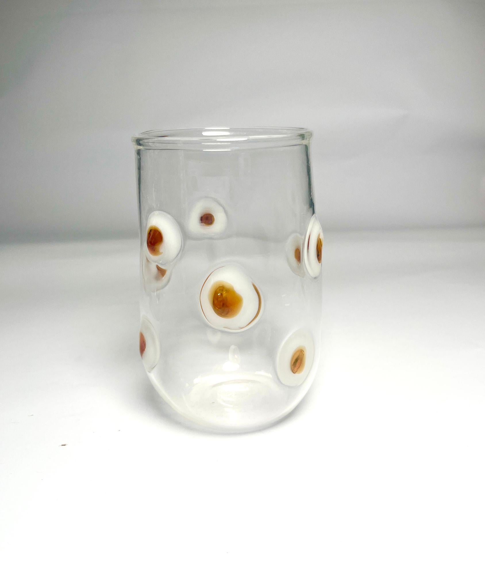 Satz von 6 Wassergläsern aus weißem Glas, die jeweils mit zarten, erhabenen weißen und gelben Punkten verziert sind. Dieses verspielte und doch elegante Design verleiht jedem gedeckten Tisch Originalität und Charme. Perfekt für den täglichen