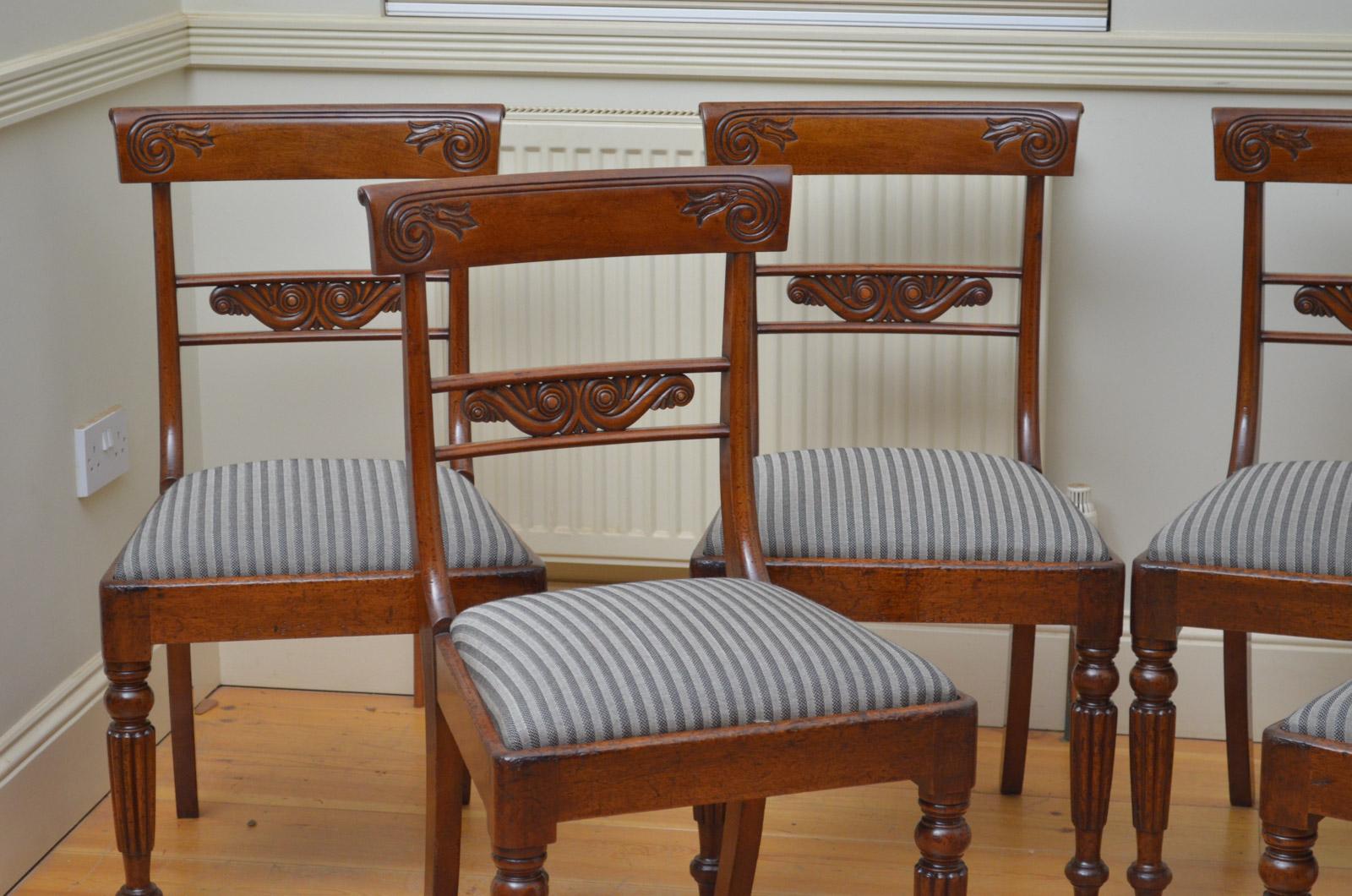Sn4448, set of six mahogany dining chairs, each having shaped can carved top rails with finely carved mid rail below, drop in seat covered in complementary fabric, standing on turned and fluted legs. This set of antique dining chairs retains