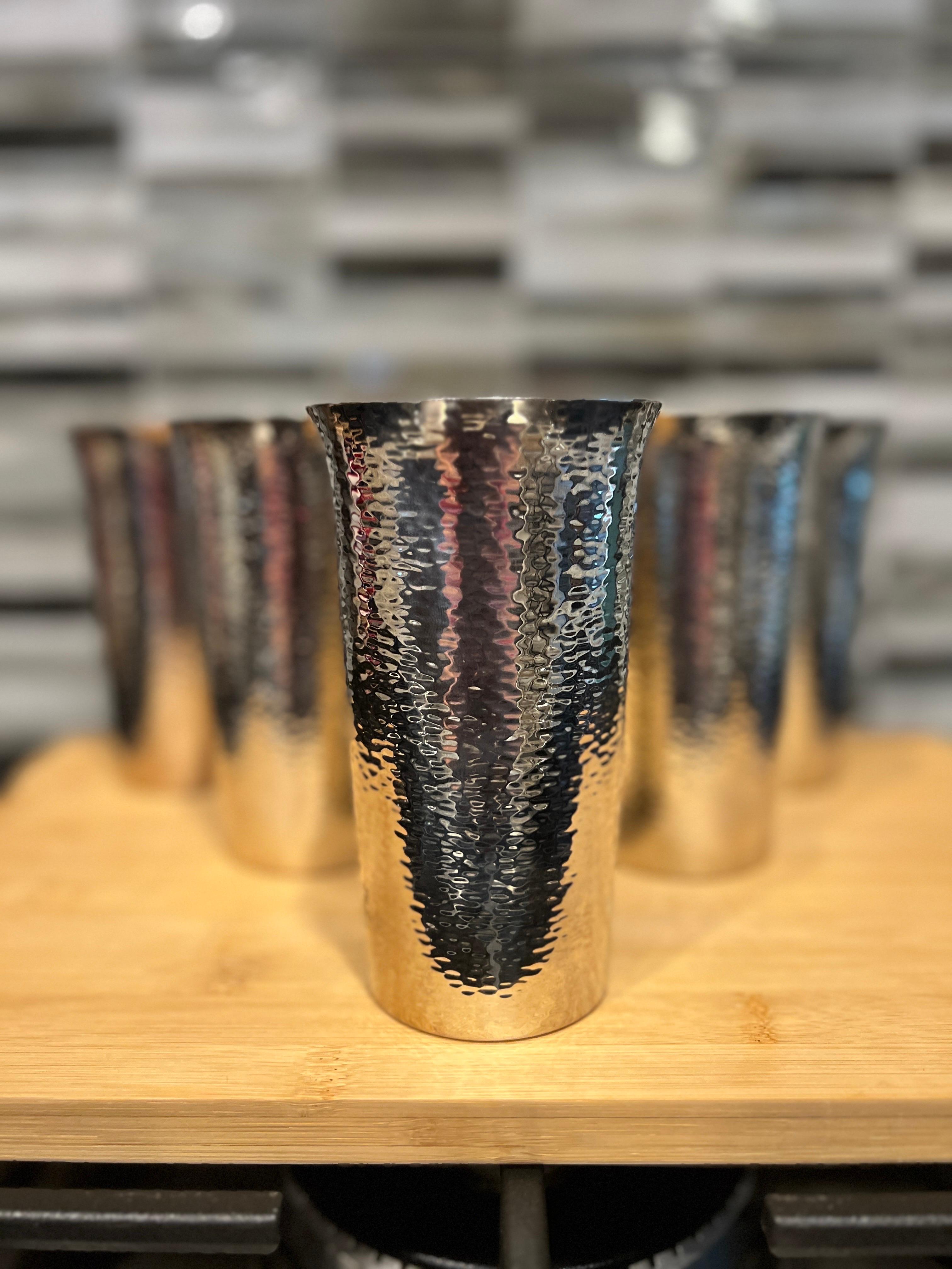 American, 20th century.

A great grouping of 6 American silver plated tumblers or iced tea glasses. Each piece is beautifully hand hammered to give a fantastic surface feel and appearance. Marked appropriately to underside. 
