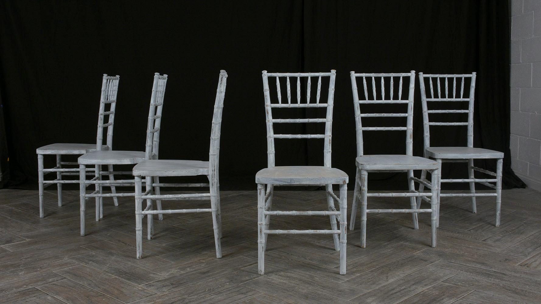 Introduce a touch of vintage charm to your dining area with our set of six dining chairs, meticulously crafted out of solid wood and featuring a carved faux bamboo design. In good condition and professionally restored by our expert craftsmen, these