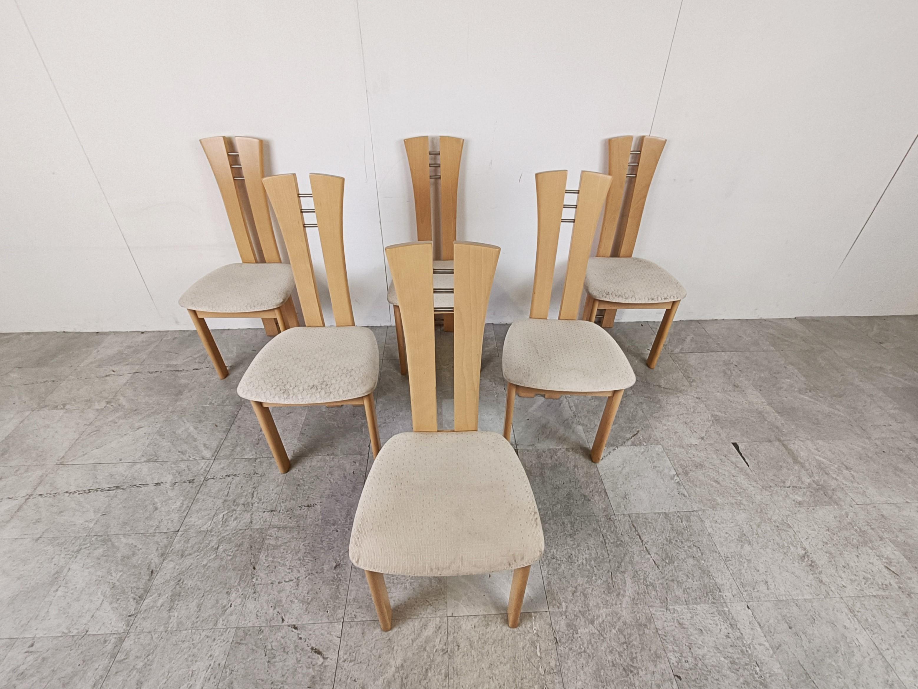 Belgian design high back wooden dining chairs.

The chairs have beautiful oak frames with a split back going all the way down to form the legs and come with their original fabric seats.

Dimensions: 
Height: 100cm/39.37
