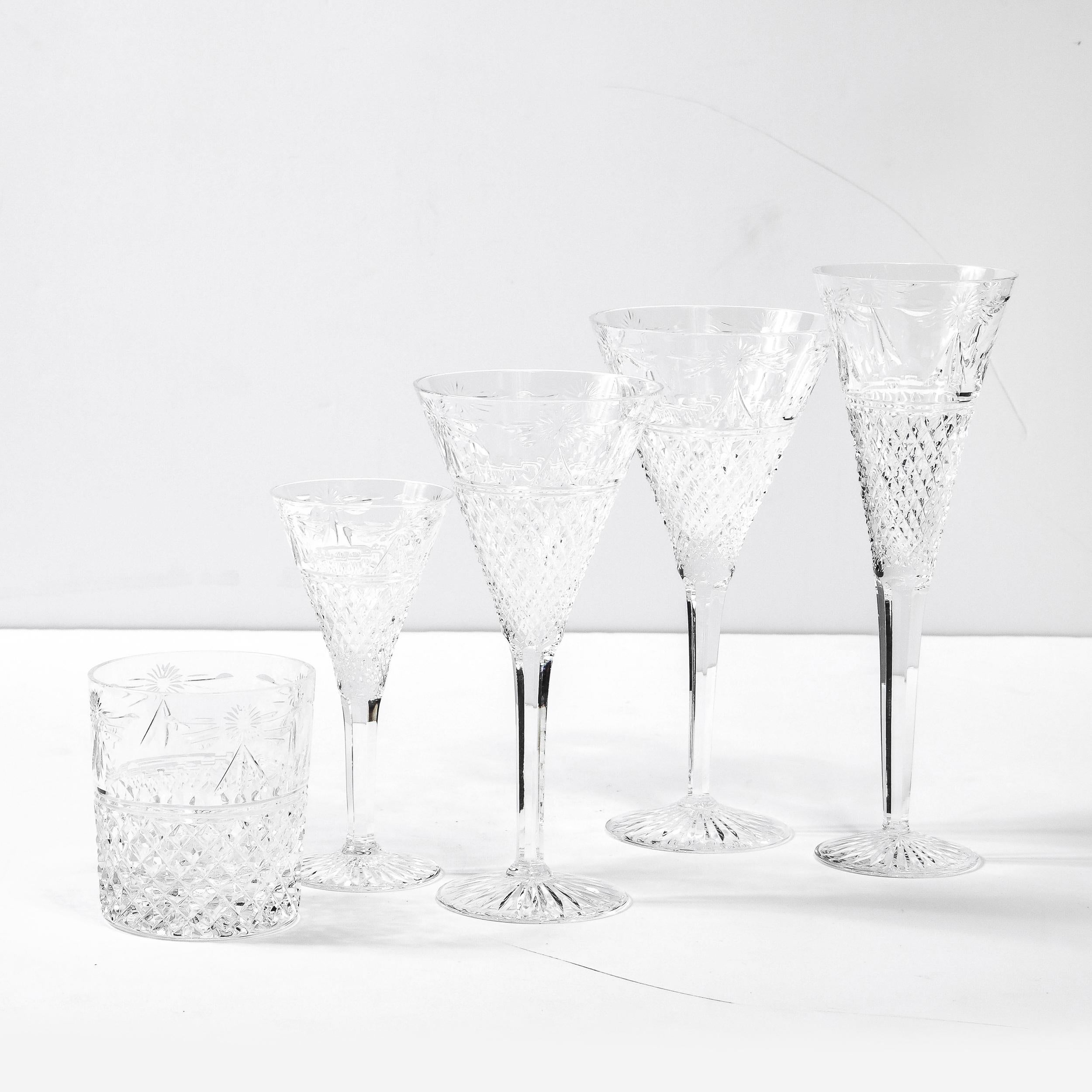 This stunning set of 60 glasses were realized by the renowned British maker, Stuart, in England during the latter half of the 20th Century. The set features 12 of the following pieces: water, champagne, wine, cocktail and lowball glasses. Each of