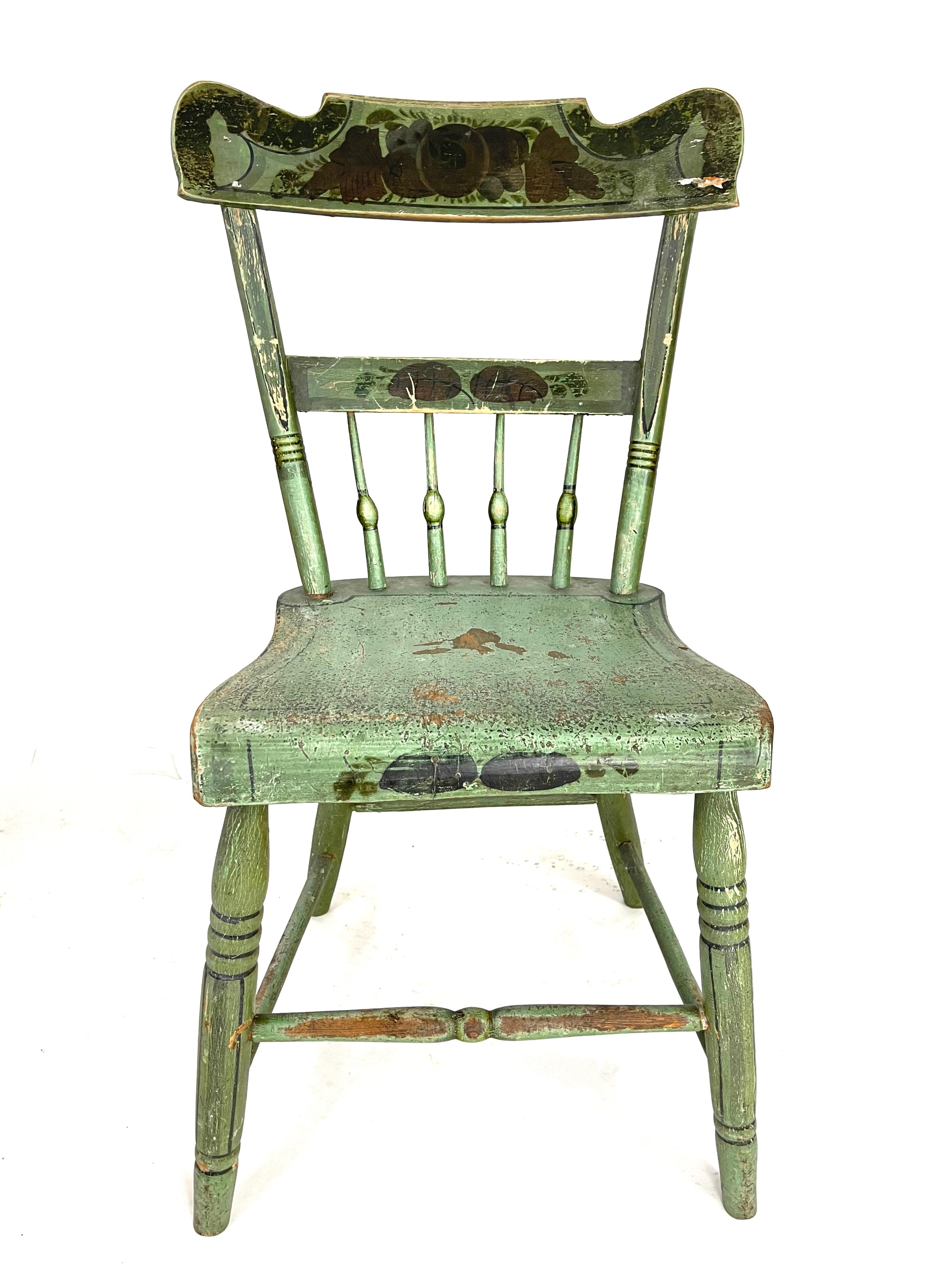 A set of set of six 19th century American country dining chairs retaining their original light green painted surface, the crests of each decorated with stenciled designs of fruit and foliage, possibly New England, circa 1820-30. Beautiful color,
