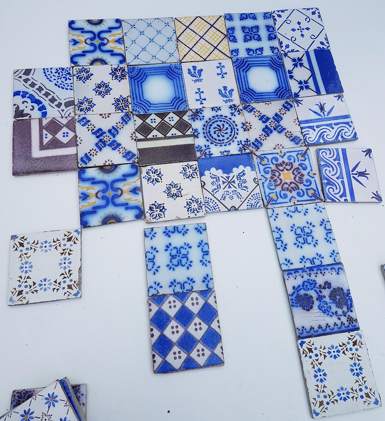 This is an amazing and unique set of 64 antique French handmade ceramic tiles. Manufactured Pas de Calais Desvres, circa 1910s. With different stylized designs. These tiles would be charming displayed on easels, framed or incorporated into a custom