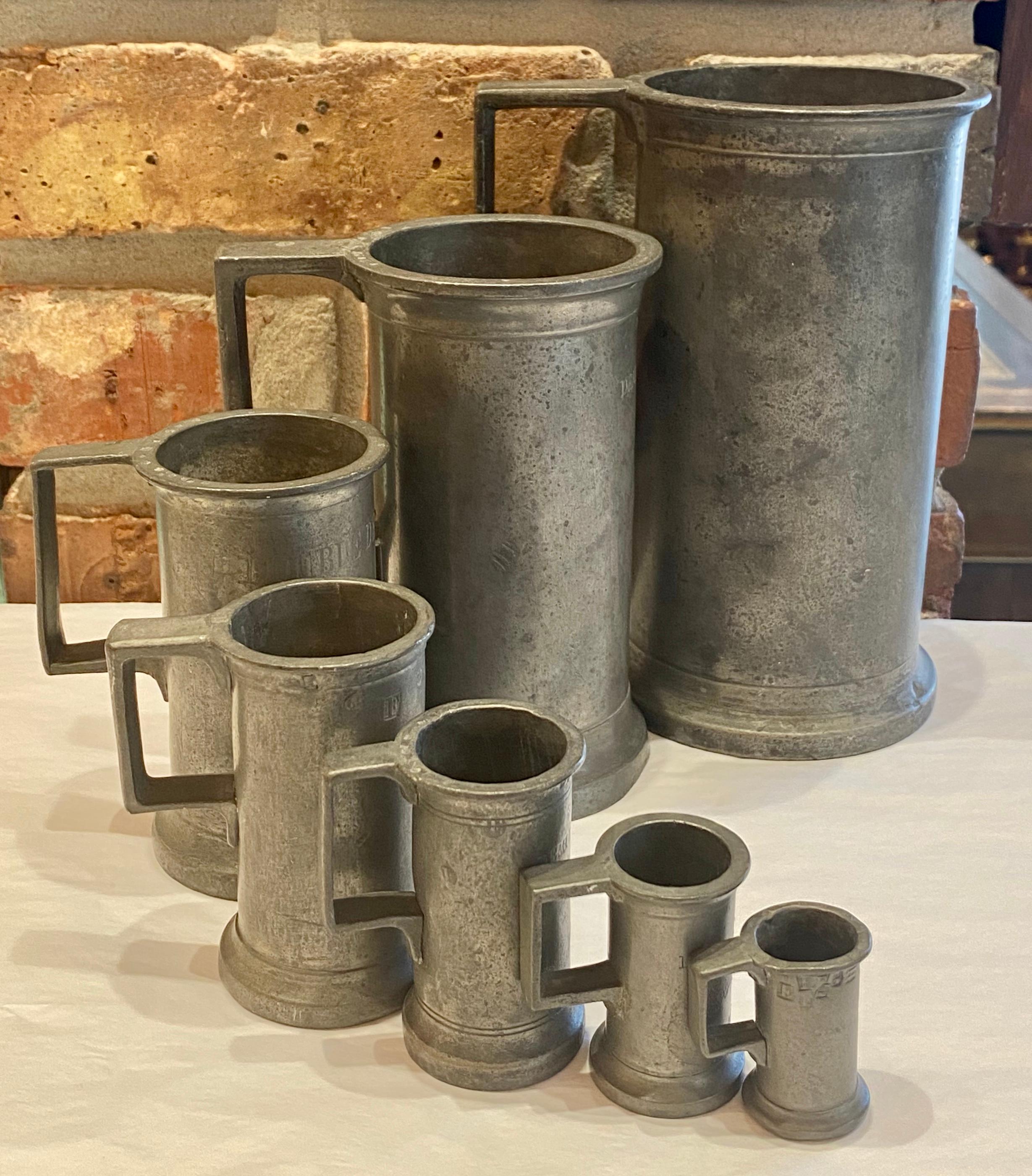 Set of 7 antique French heavy pewter graduated measuring tankards signed, 