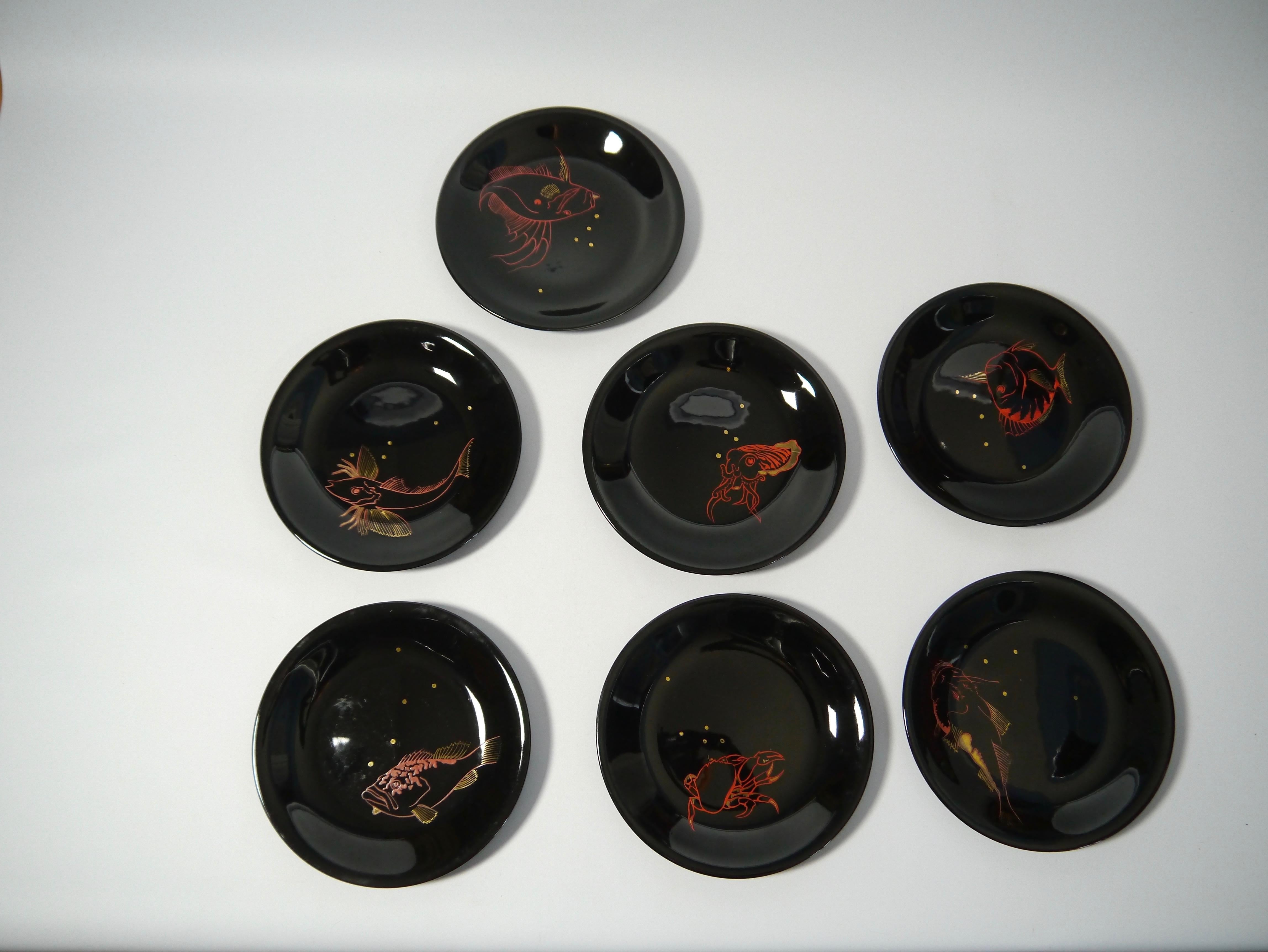 A set consisting of 7 black porcelain seafood dining plates. hand painted with 7 different aquatic animals.