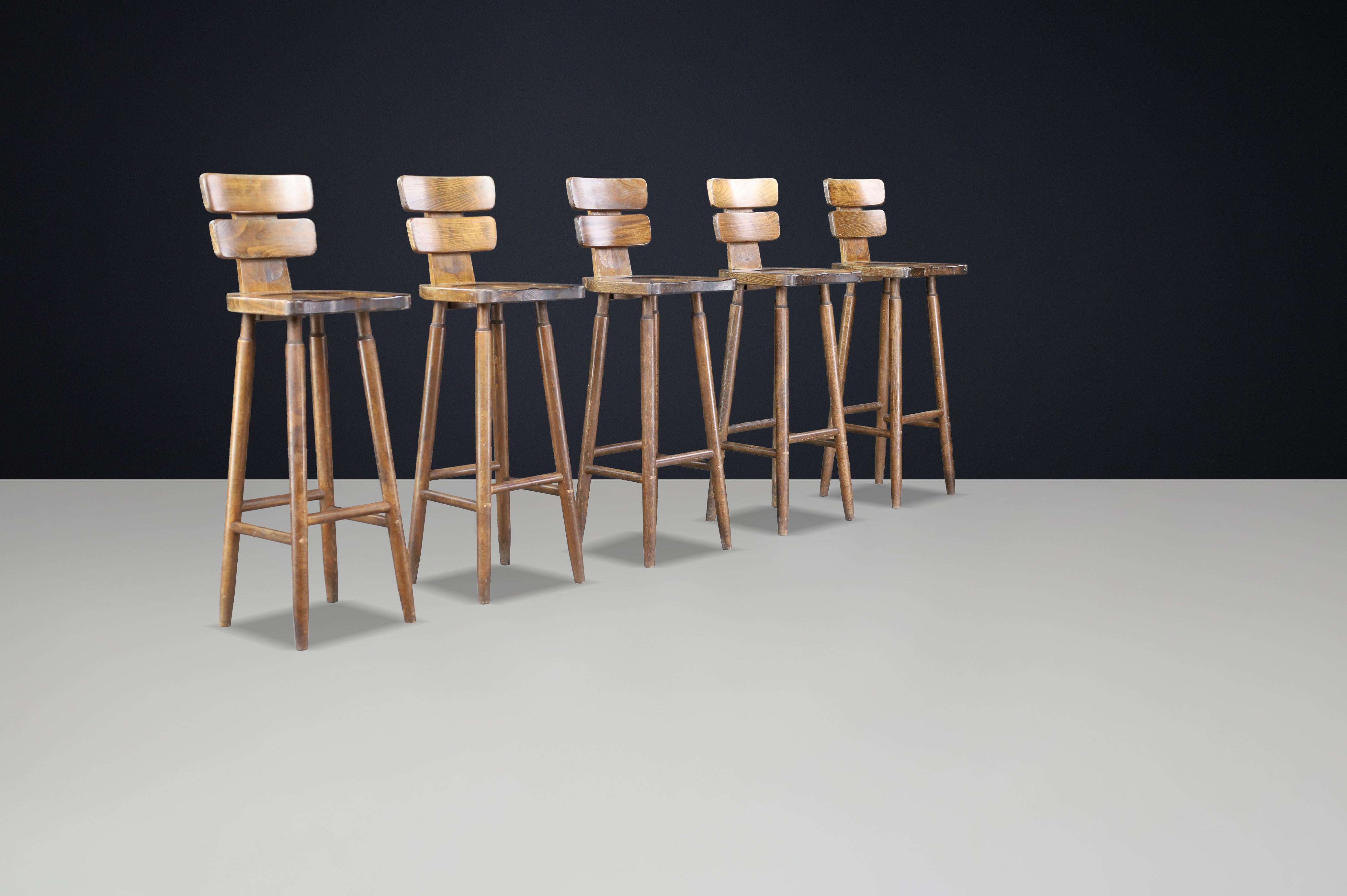 20th Century Set of 7 Brutalist Bar Stools in Patinated Beechwood, France, 1960s For Sale