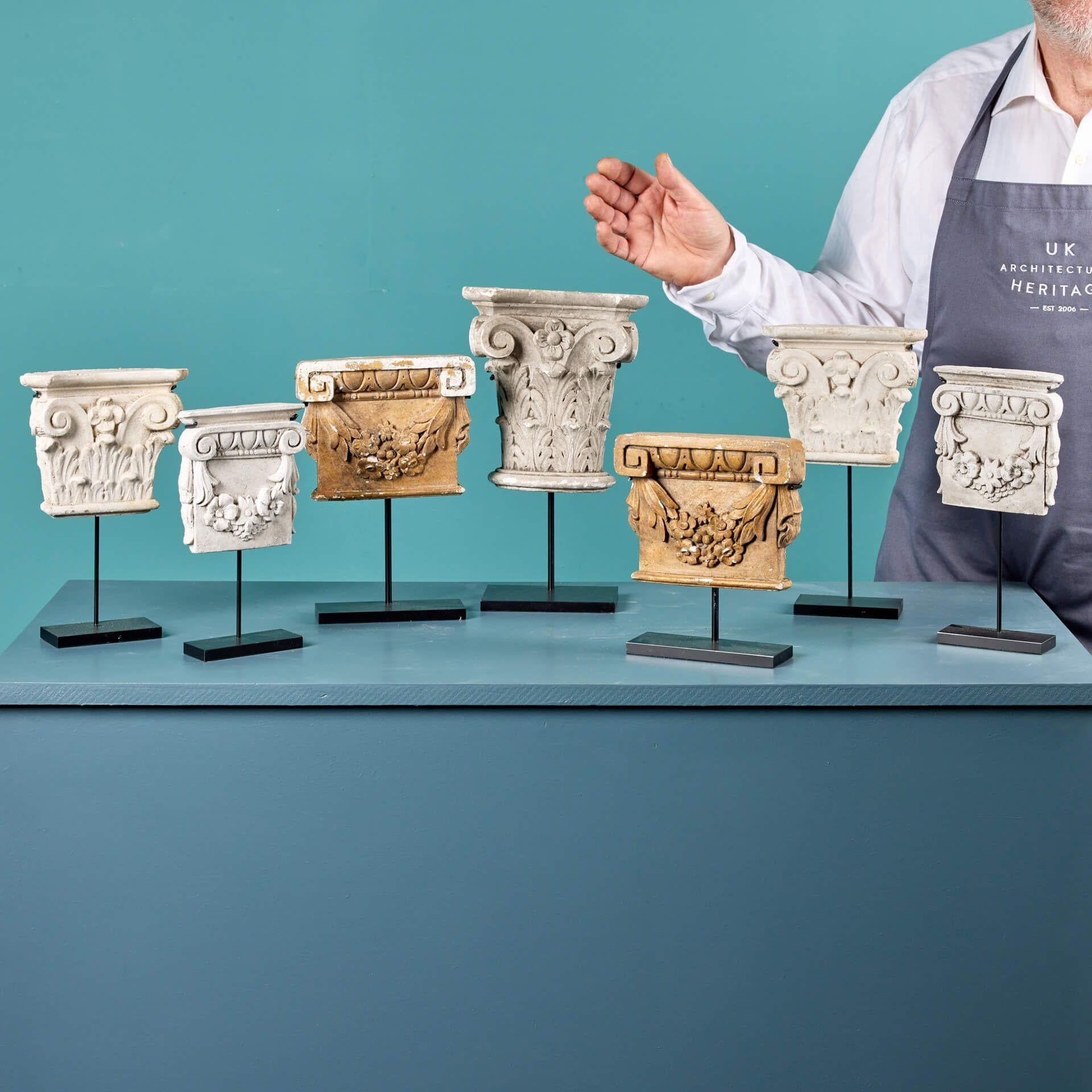 A set of 7 decorative antique plaster capitals of French origin, circa 1880. The set are displayed on bespoke steel stands at different heights to create your own graduated display of architectural mouldings. Each has an intriguing timeworn look