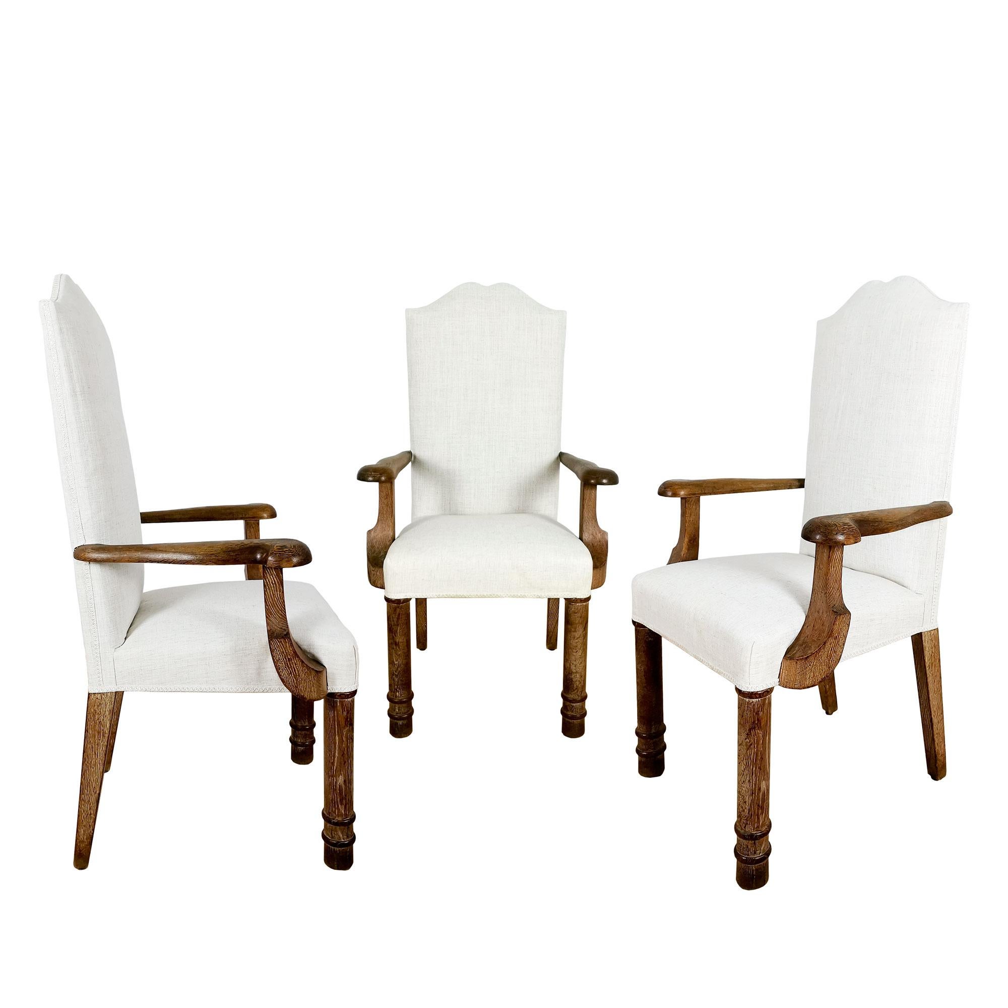 Set of 7 dining room armchairs in solid oak with ceruse patina, reupholstered in ecru linen fabric.

In the style of Jacques Adnet.

France c. 1940