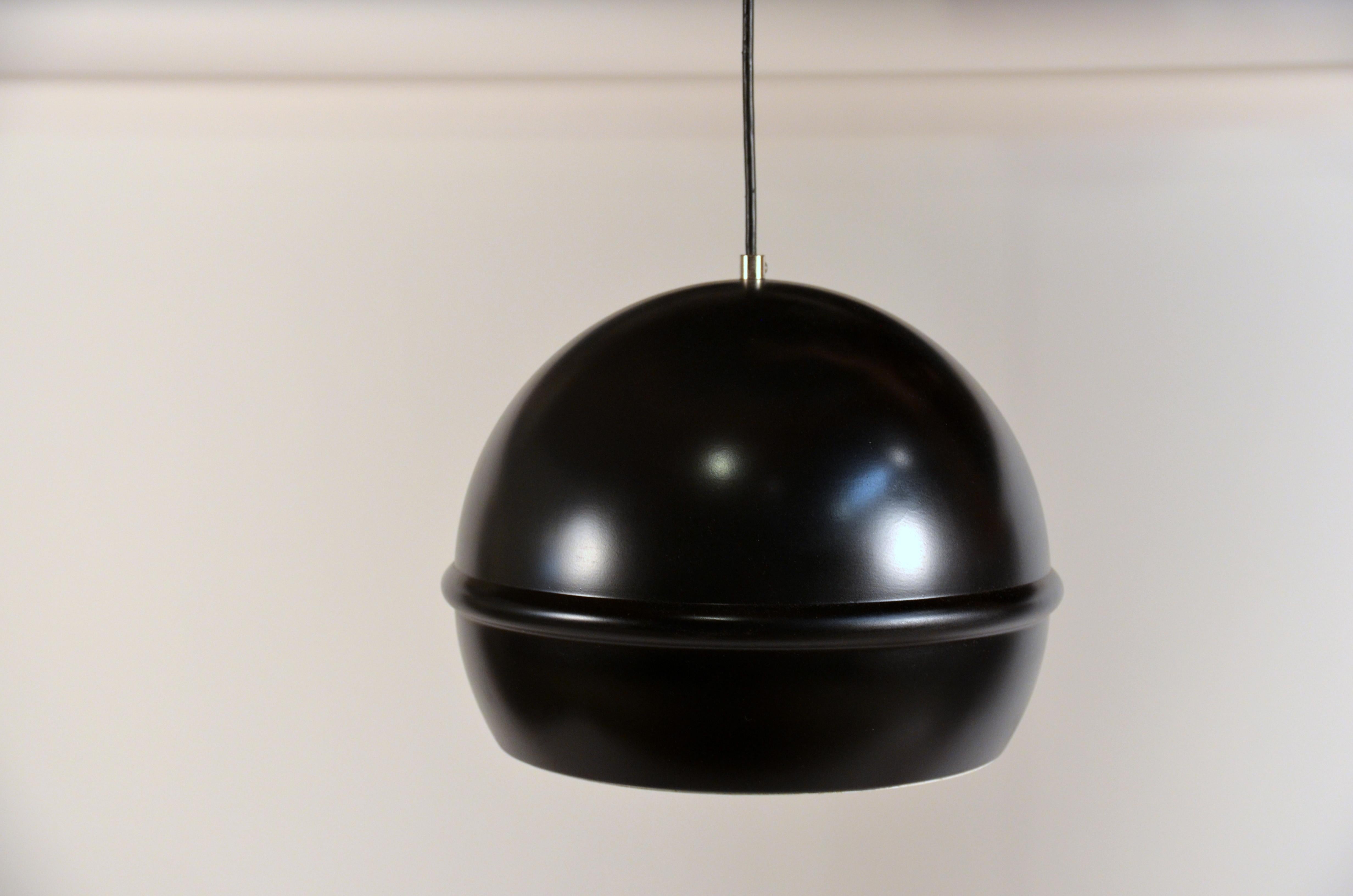 Set of 7 French 1960s black globe pendants. Matching canopies.

Can be installed aligned, in a grid, or in a cluster at different heights.

Perfect with silver- or gold-tipped bulbs.

Priced as a set of 7 but can also be sold individually; please